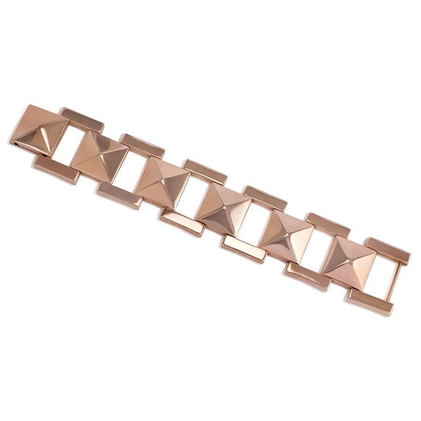 A Retro rose gold bracelet composed of pyramidal plaque links and horizontal bar borders, completed by a foldover clasp, in 14k.  Tiffany & Co.