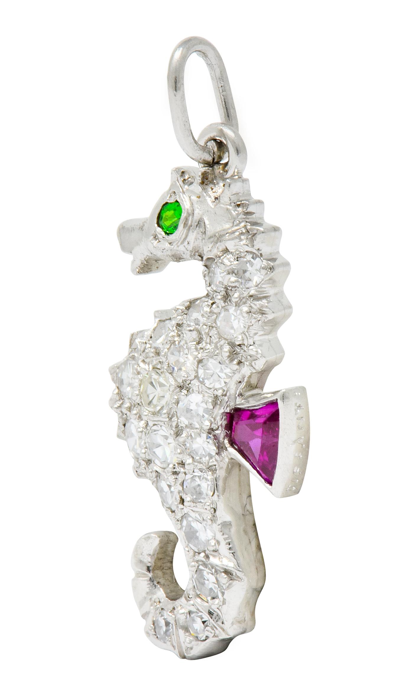 Charm is designed as a poised seahorse with a coiled tail and a raspberry red calibré cut ruby fin

Accented by a round cut demantoid garnet eye, lime green in color

Body is pavé set throughout by single cut diamonds, eye-clean and white

Signed
