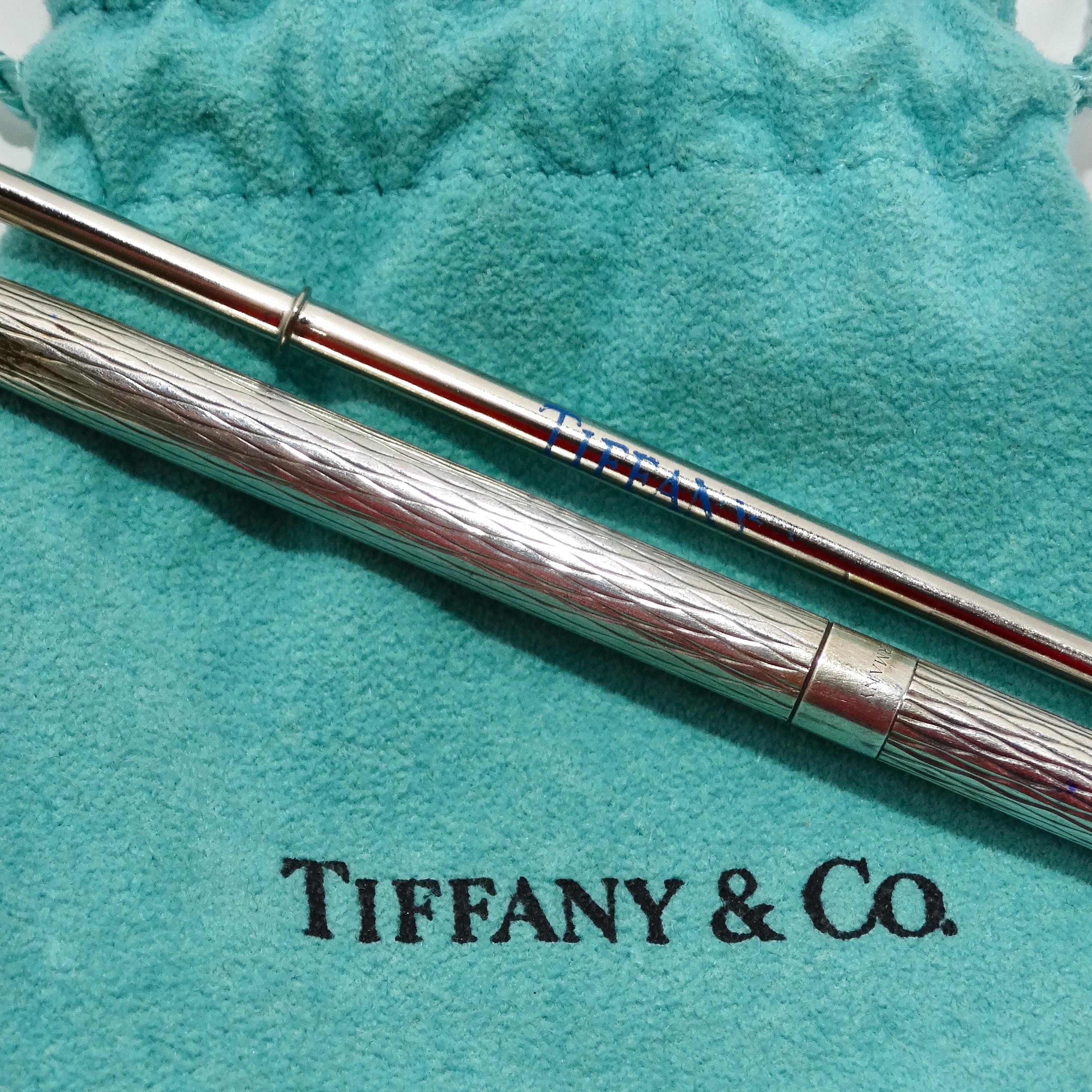 Introducing the exquisite Tiffany & Co 1950s Pure Silver Pen & Ink Set, a timeless and luxurious addition to any desk or workspace. Crafted from pure silver, this vintage Tiffany & Co pen showcases a sophisticated geometric etched design, adding an