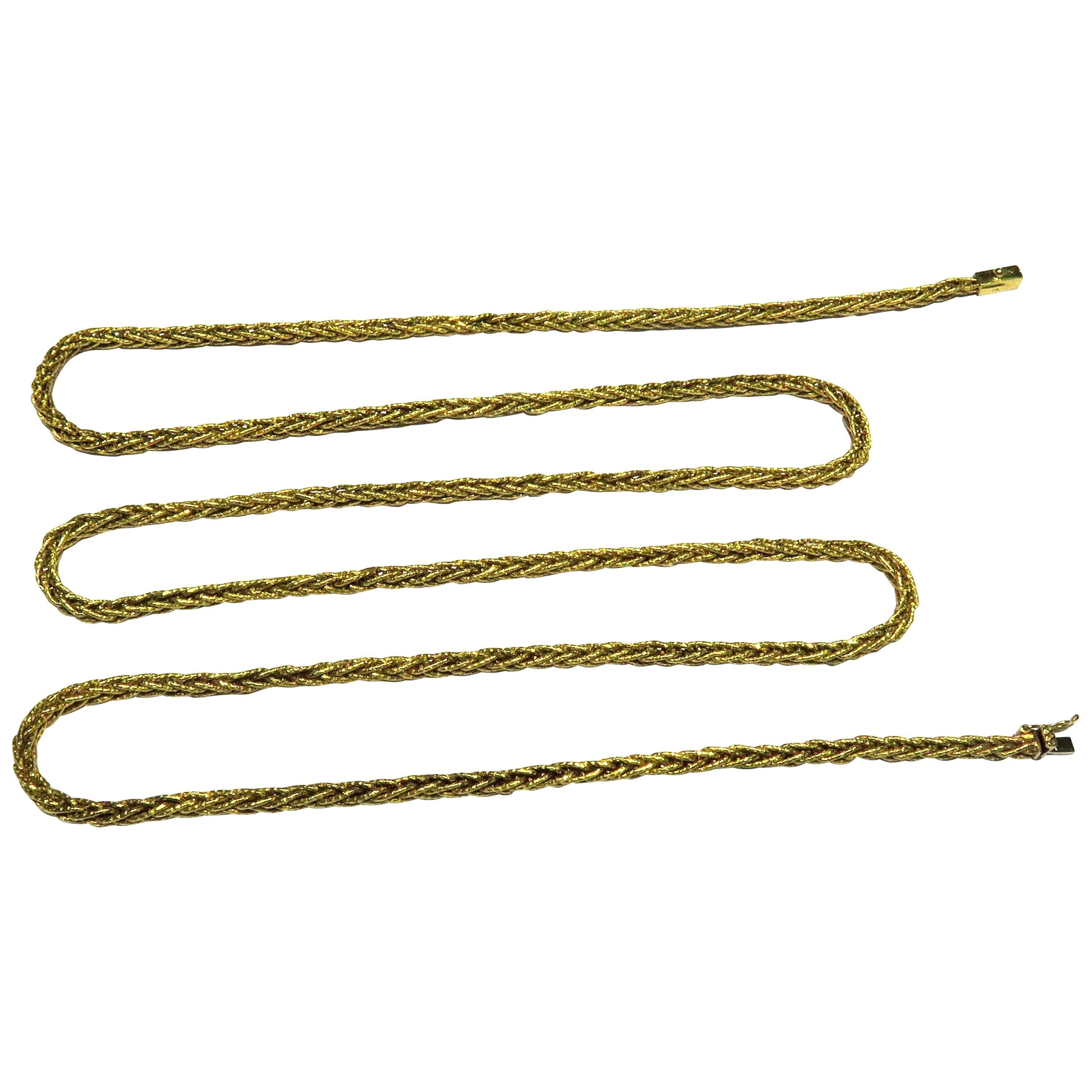 Tiffany 18 Karat yellow gold extra long woven chain. This classic chain can be worn long or doubled for a two chain look or even add a pendant or charm. This chain can be worn alone for a dramatic look or worn with other chains for a layered