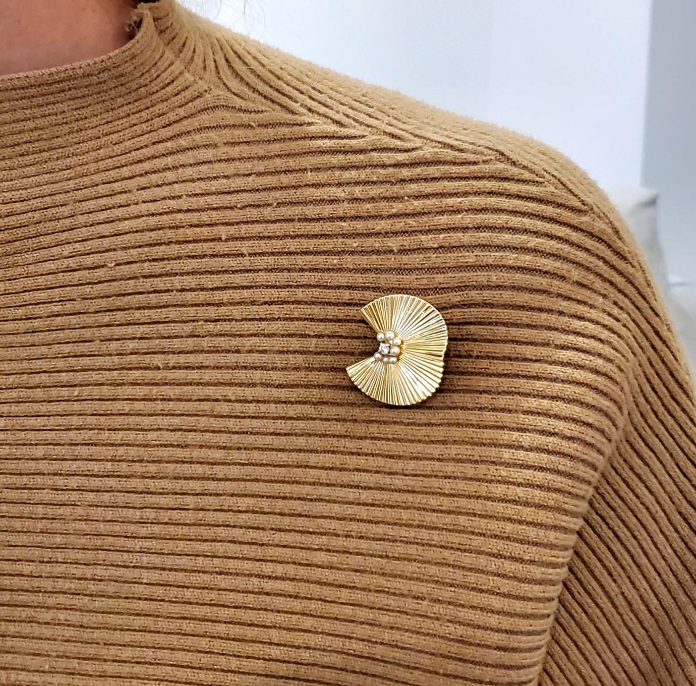 A brooch designed by George Schuler for Tiffany & Co.

A beautiful brooch, created in New York city by George Schuler for Tiffany & Co., back in the 1960. This piece has been crafted with an undulate fan shape in solid yellow gold of 14 karats with