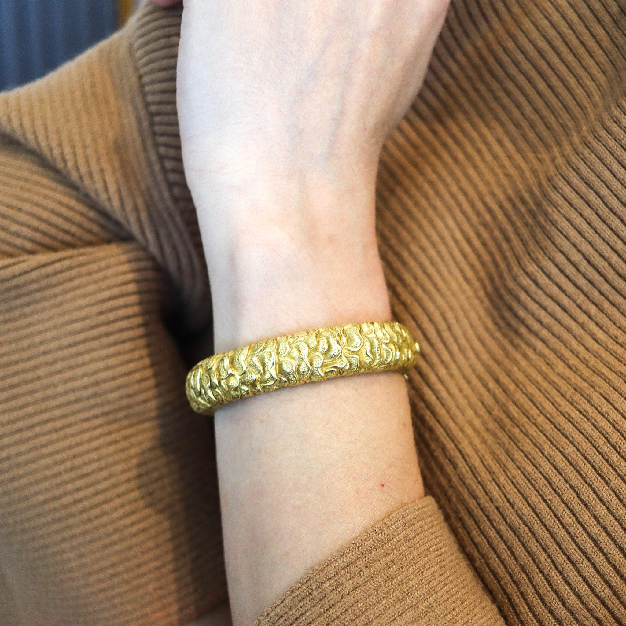 A sculpted bangle bracelet designed by Tiffany & Co.

This is a great bangle bracelet created by the jewelry house of Tiffany & Co. back in the 1960. The statement bracelet has been sculpted with chinoiserie patterns in solid yellow gold of 18