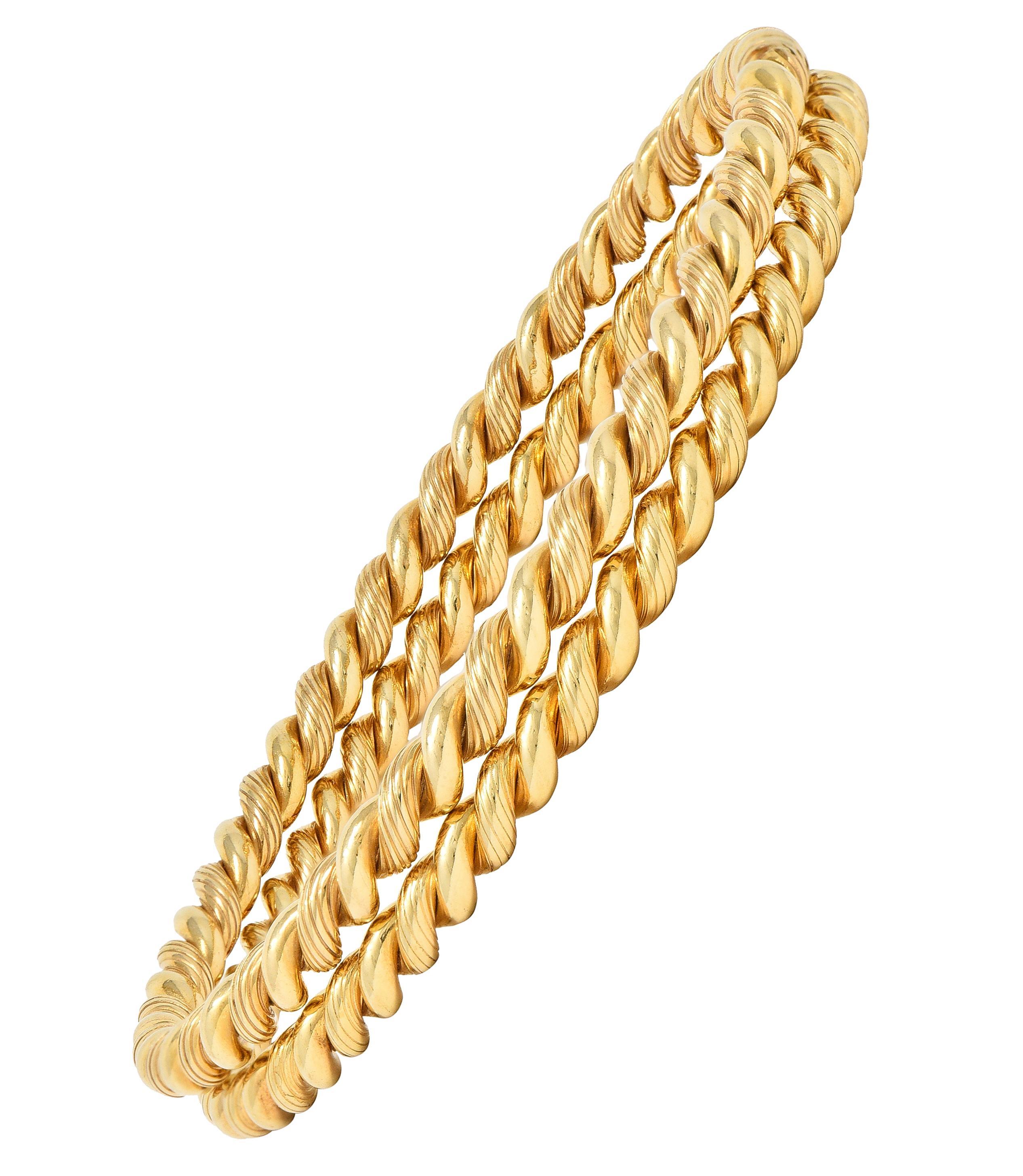 Designed as a set of round twisted rope motif bangles
Featuring twisted, smooth and textured segments
With a high polish finish
Stamped for 14 karat gold 
Signed for Tiffany & Co. 
Circa: 1960s 
Width at widest: 3/16 inch
Bracelet size: 7 3/4 inch