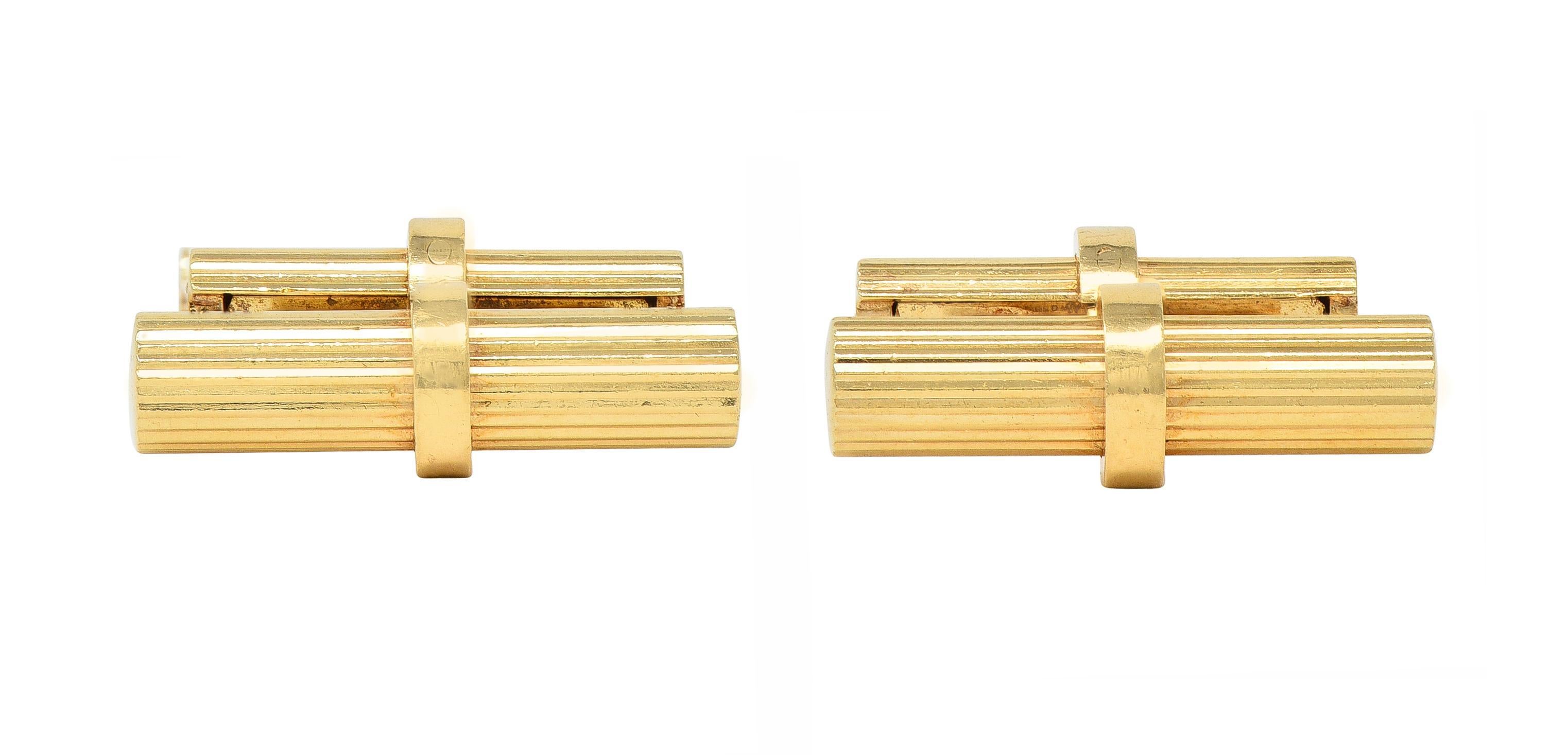 Bar-style cufflinks feature hinged barrel terminals 
One large and one small - fluted fully around 
With high polish finish 
Stamped for 14 karat gold
Fully signed for Tiffany & Co. 
Circa: 1960s
Small terminal measures: 3/16 x 13/16 inch
Large