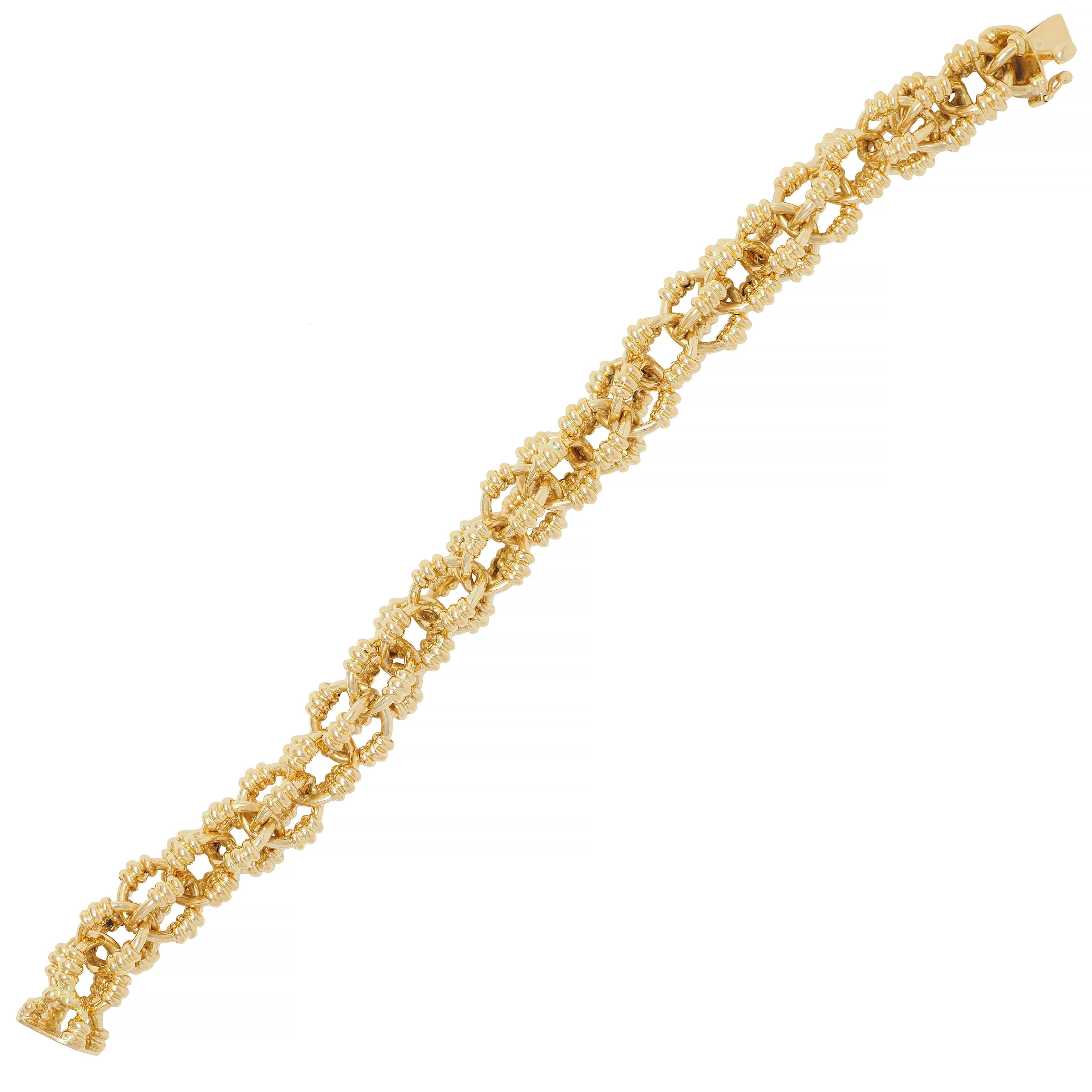Comprised of open and interlocked sphere-shaped links 
Accented by ridged detailing and high polish finish
Completed by concealed clasp closure 
With figure eight safety 
Stamped for 18 karat gold
Fully signed for Tiffany & Co., Italy
Circa: