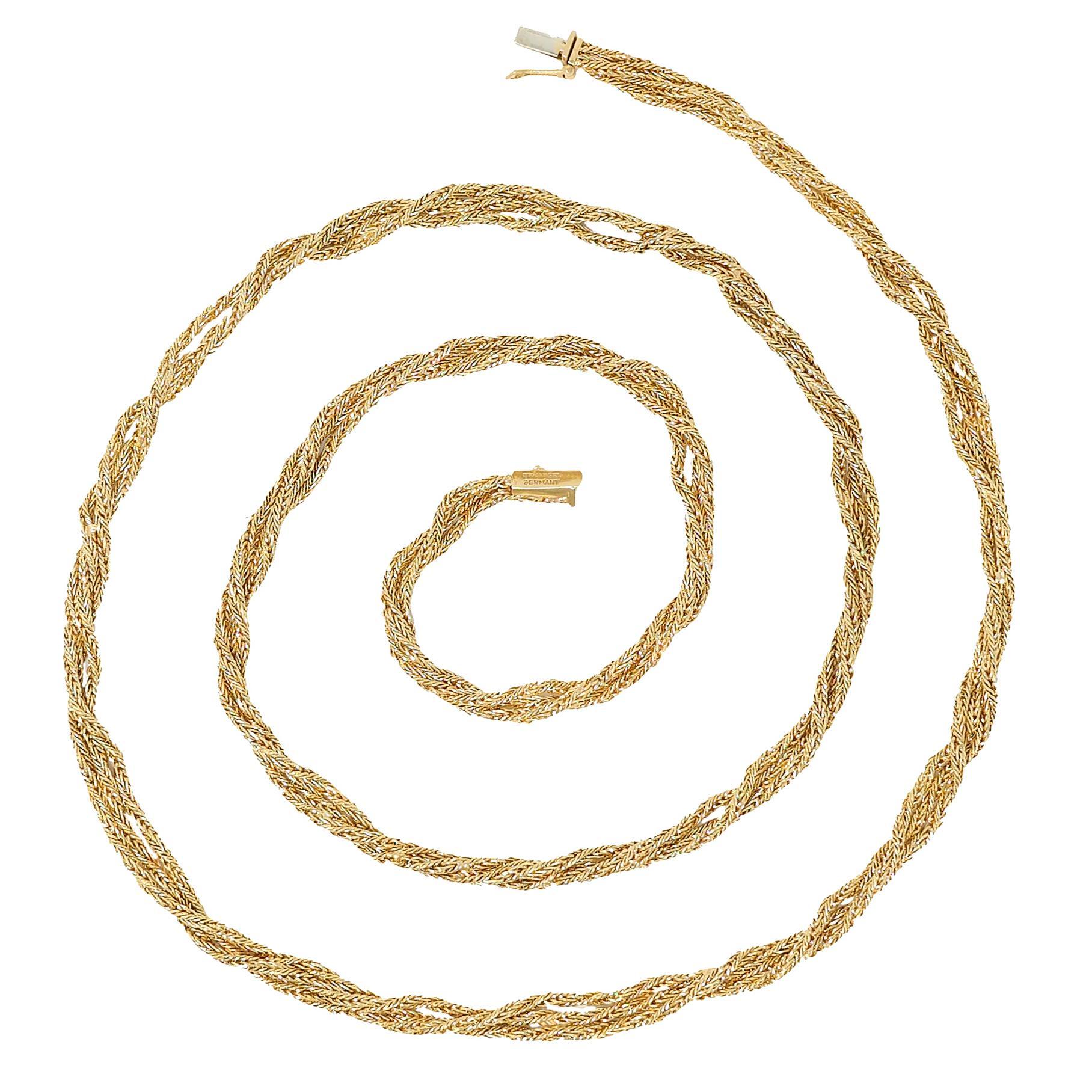 Comprised of three strands of herringbone link box chain
Twisted to create meshed rope motif
Completed by press release clasp
With a hinged figure eight safety
Stamped for 18 karat gold
Fully signed for Tiffany & Co., Germany
Circa: 1960s
Width: 1/4
