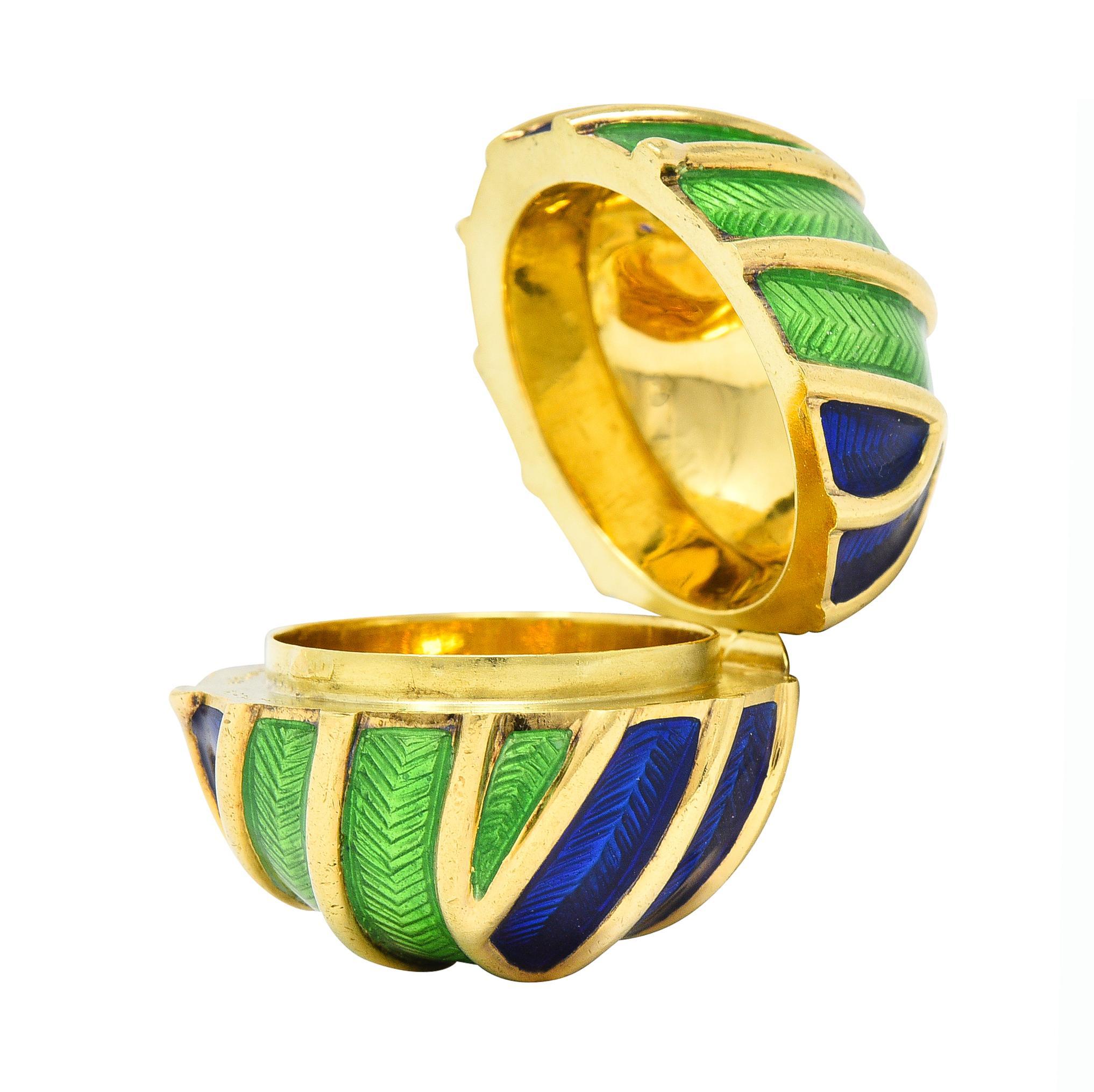 Designed as a sphere form with raised gold ridges featuring recessed segments of enamel
Basse-taille and glossed over engraved linear chevron motif 
Transparent medium blue and green - minimal loss
Sphere opens on a hinge to reveal domed