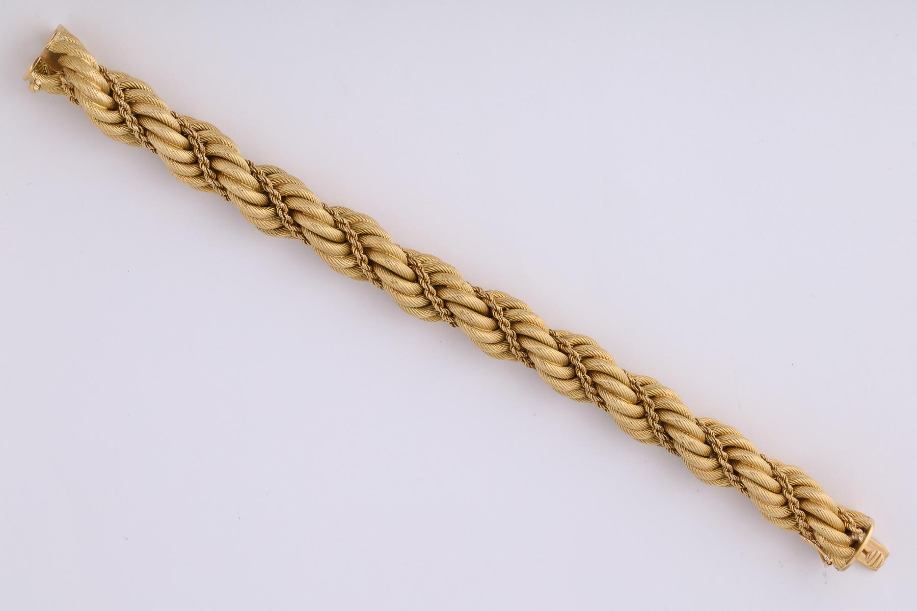 One Ladies 18kt Gold Twist Bracelet Designed In A Textured  Ridged Gold Link With A 18kt Gold Rope Thruout The Design Of Bracelet. Created In 1969 In Italy. Signed Tiffany & Co. Dated 1969 Stamped 18kt