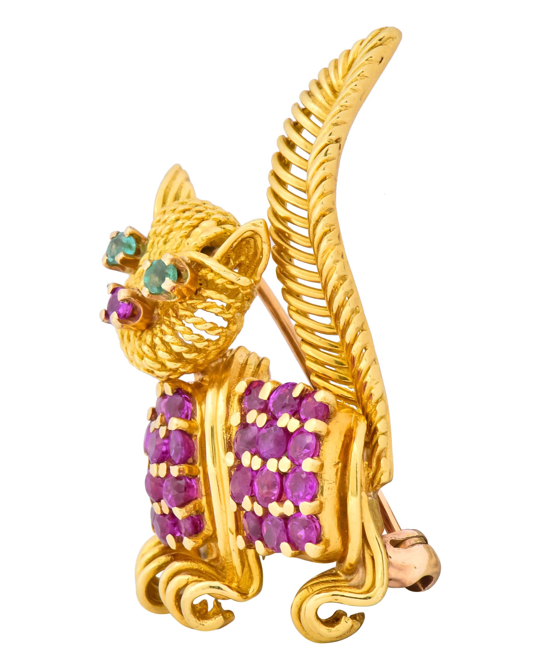 Brooch designed as a prancing cat with textured fur and whiskers 

With high polished and ribbed detailing on face, tail and nails

Set throughout with 1.50 carats of rubies, transparent and raspberry red in color

Accented by round cut emerald eyes