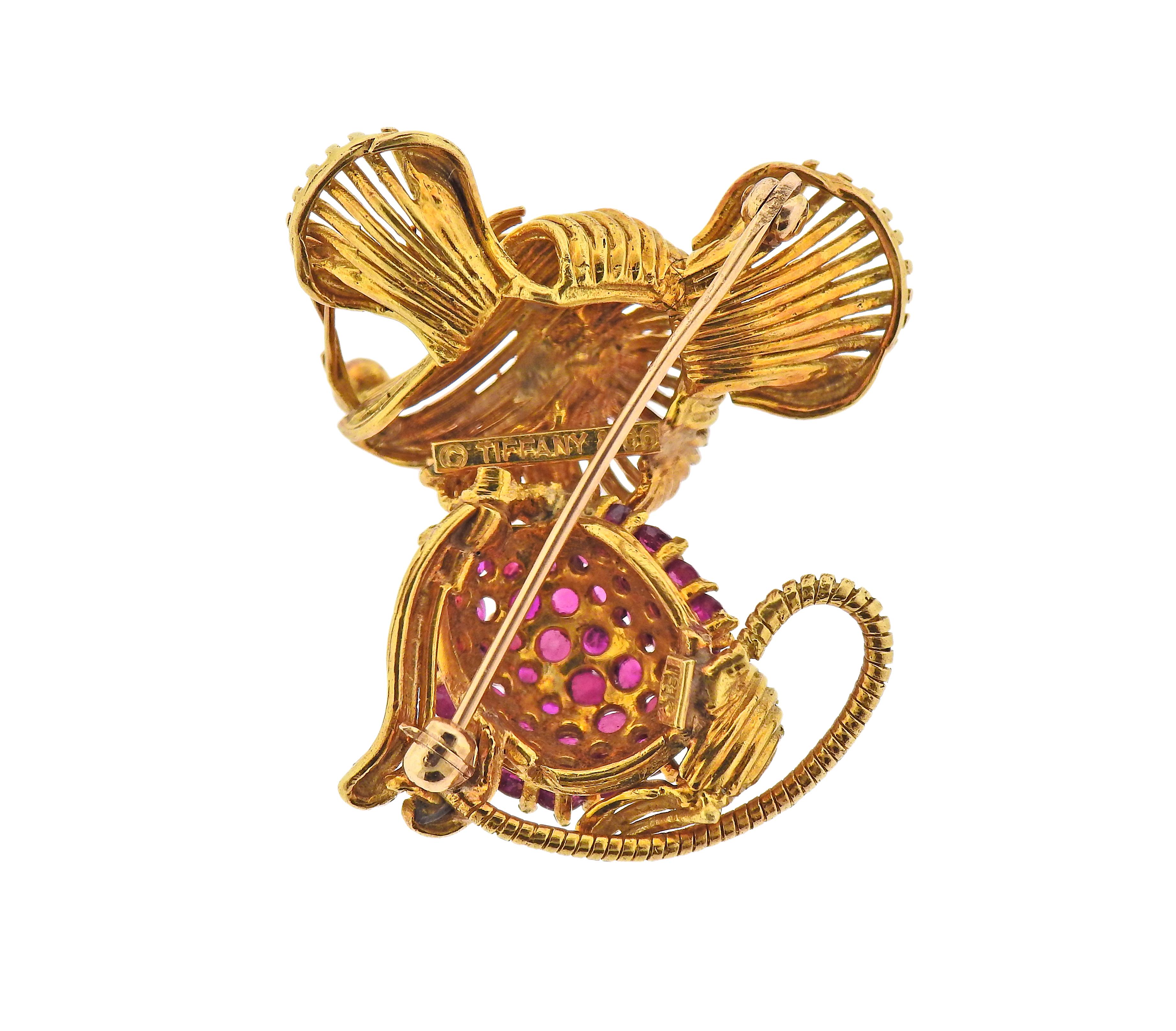 Adorable 1960s Tiffany & Co 18k gold mouse brooch, with emerald eyes and rubies on the belly. Brooch measures 35mm x 33mm. Marked: Tiffany & Co 18k. Weight - 14.9 grams.