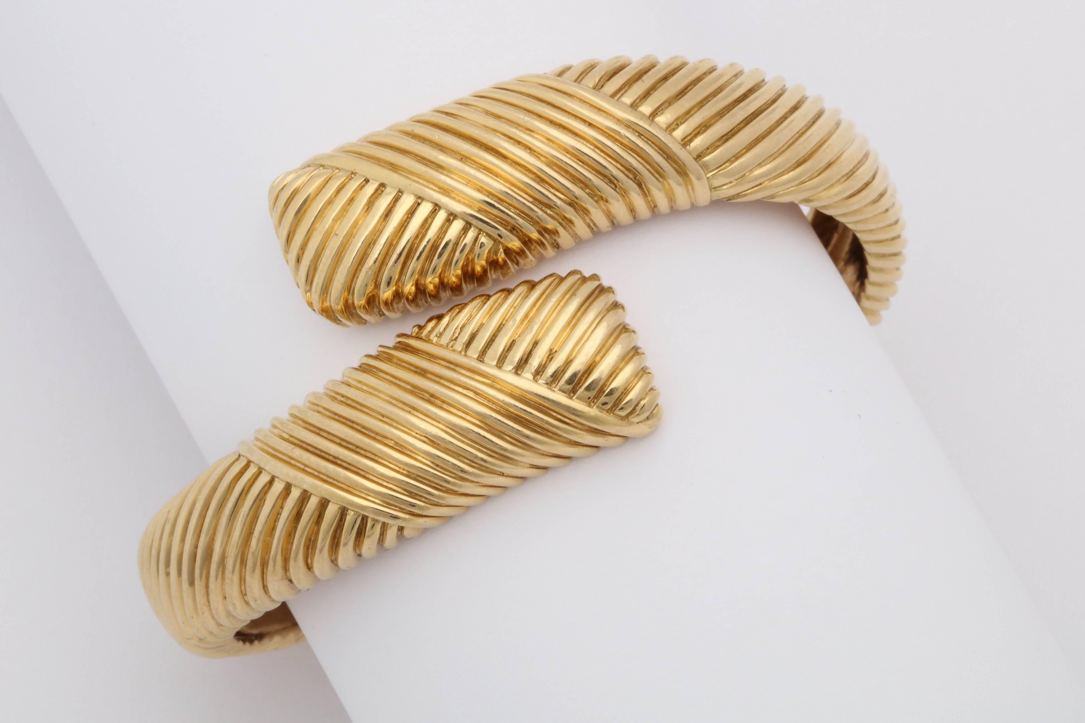 One Ladies 18kt Yellow Gold Crossover Hinged Bangle Bracelet Designed With A Diagonal Textured Ridged Pattern.One Size Fits Al,l Designed By Tiffany & Co. In The 1960's.