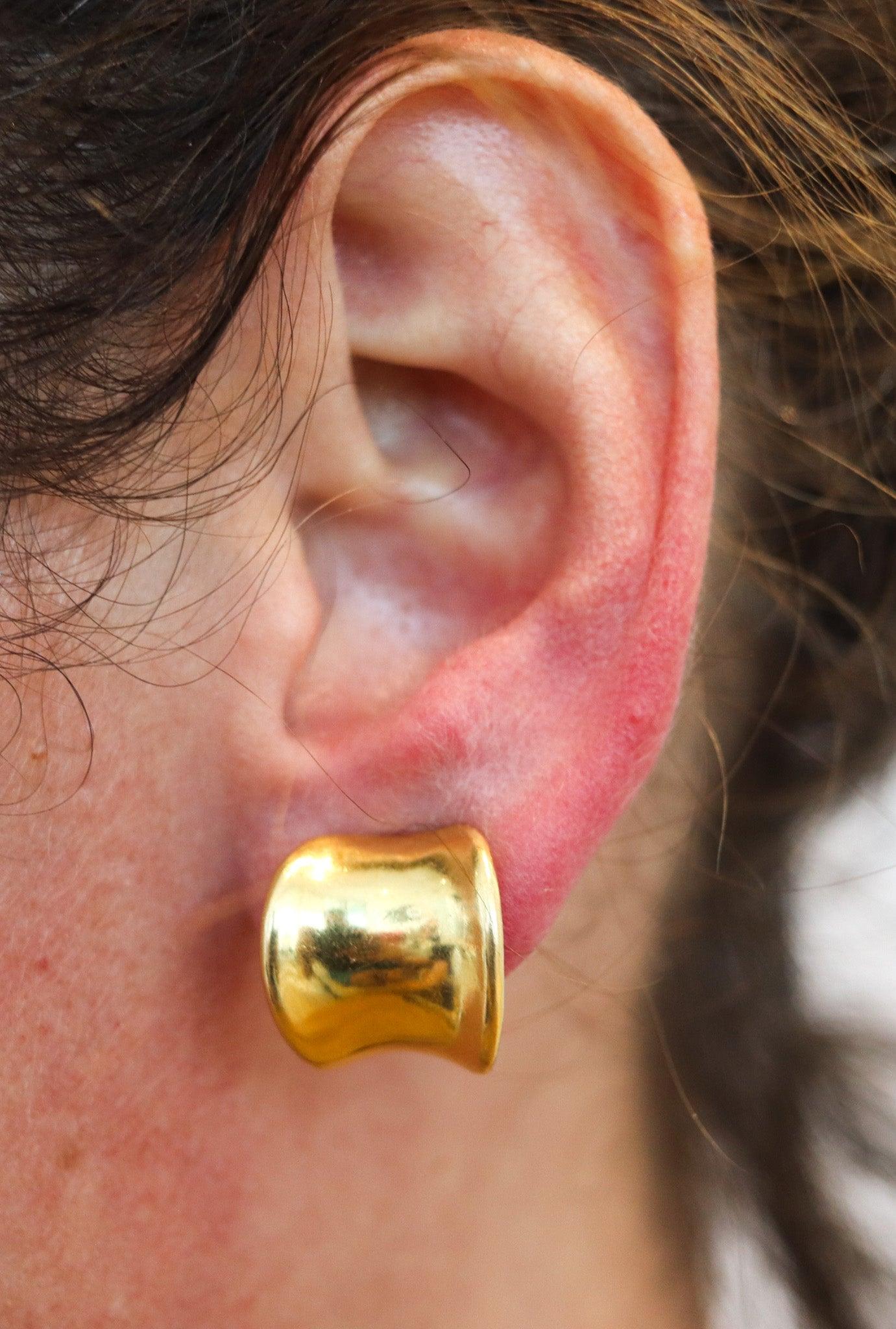 Curved hoops earrings designed by Tiffany & Co.   

These are a very unusual pair of hoops earrings created in New York City by the jewelry house of Tiffany & Co. back in the 1970. The beautiful earrings have been crafted with curved concave shapes