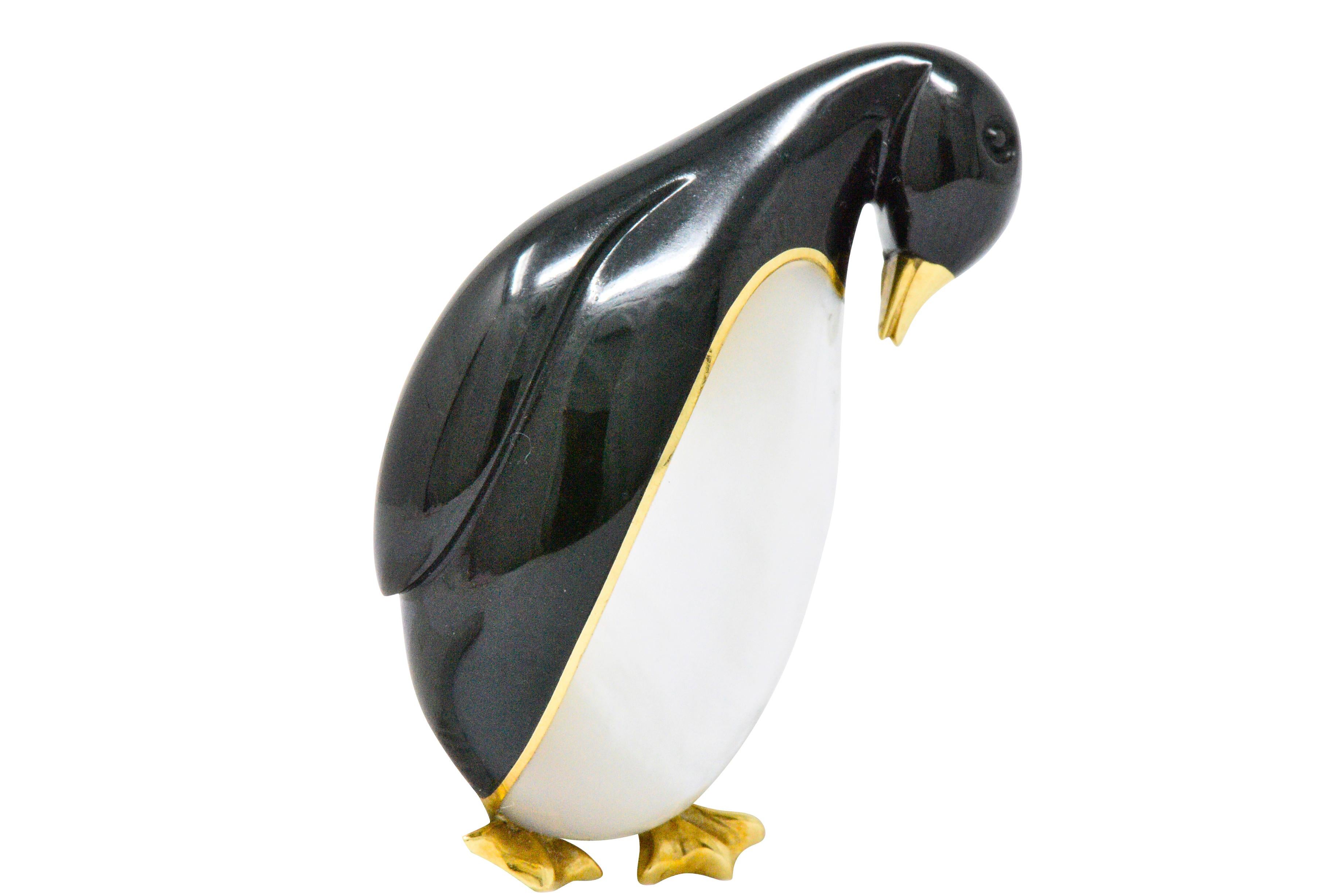 Designed as an emperor penguin with carved black jade and mother-of-pearl body
Polished gold webbed feet, beak and detailing
Fully signed Tiffany & Co.
Circa 1970
Measuring: 1 5/8 x 3/4 inches
Total Weight: 13.8 Grams
Adorable. Whimsical. Cute. 
 

