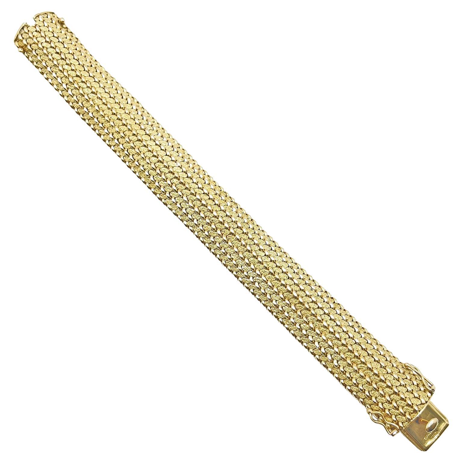Tiffany woven 14k yellow gold bracelet, featuring a curved design with a polished beaded accent with a textured finish in between.  Signed 'Tiffany & Co' 'S14KS' on the underside of the clasp and '14k' on the tongue.  Double safety latches. 
 0.75