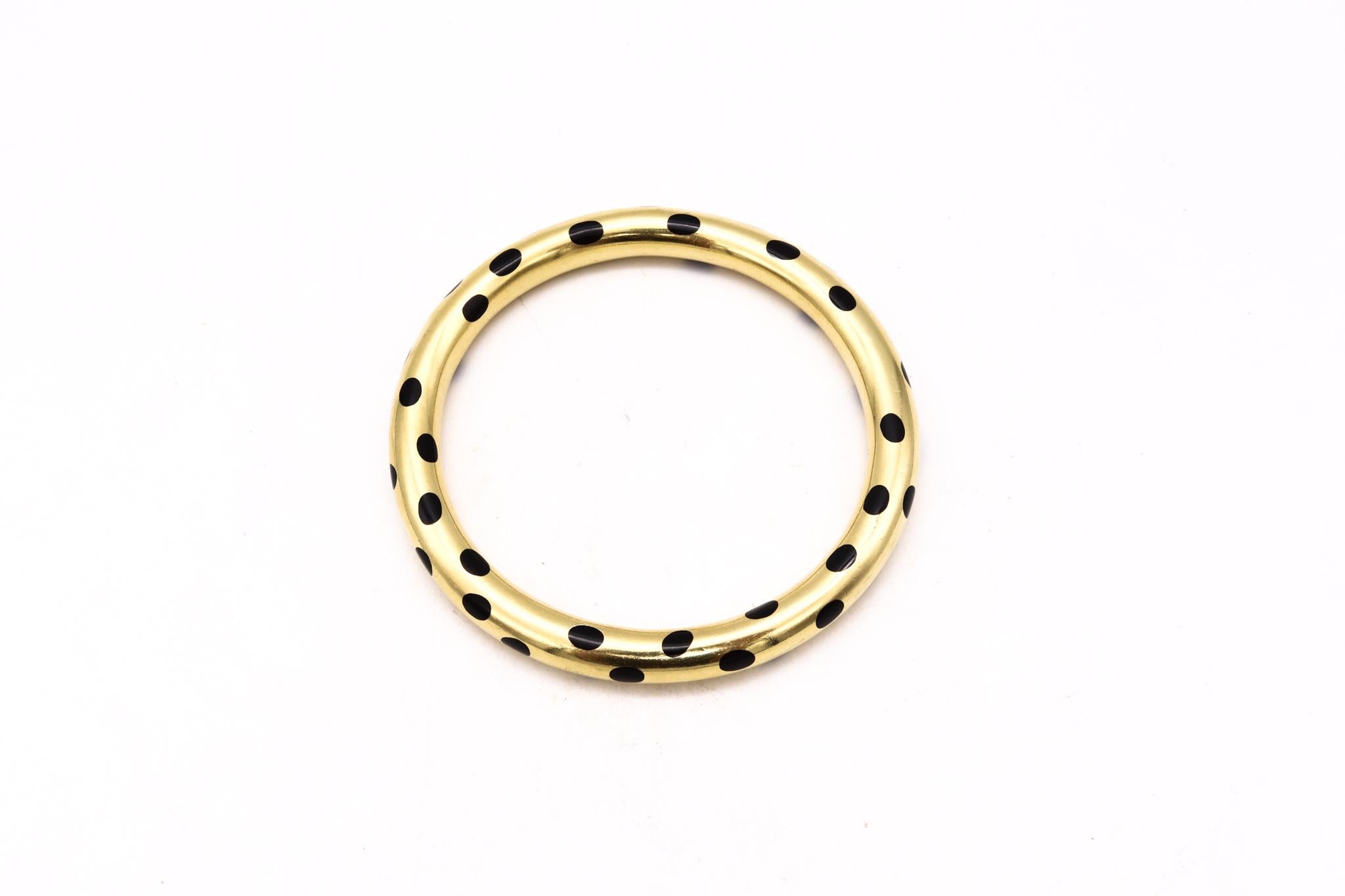 Dotted bangle designed by Angela Cummings for Tiffany & Co.

This unusual bangle was part of the Tiffany & Co. collection from the years of 1975 and 1976. Commonly known as the Dalmatian bangle, was crafted by Angela Cummings in solid yellow gold of
