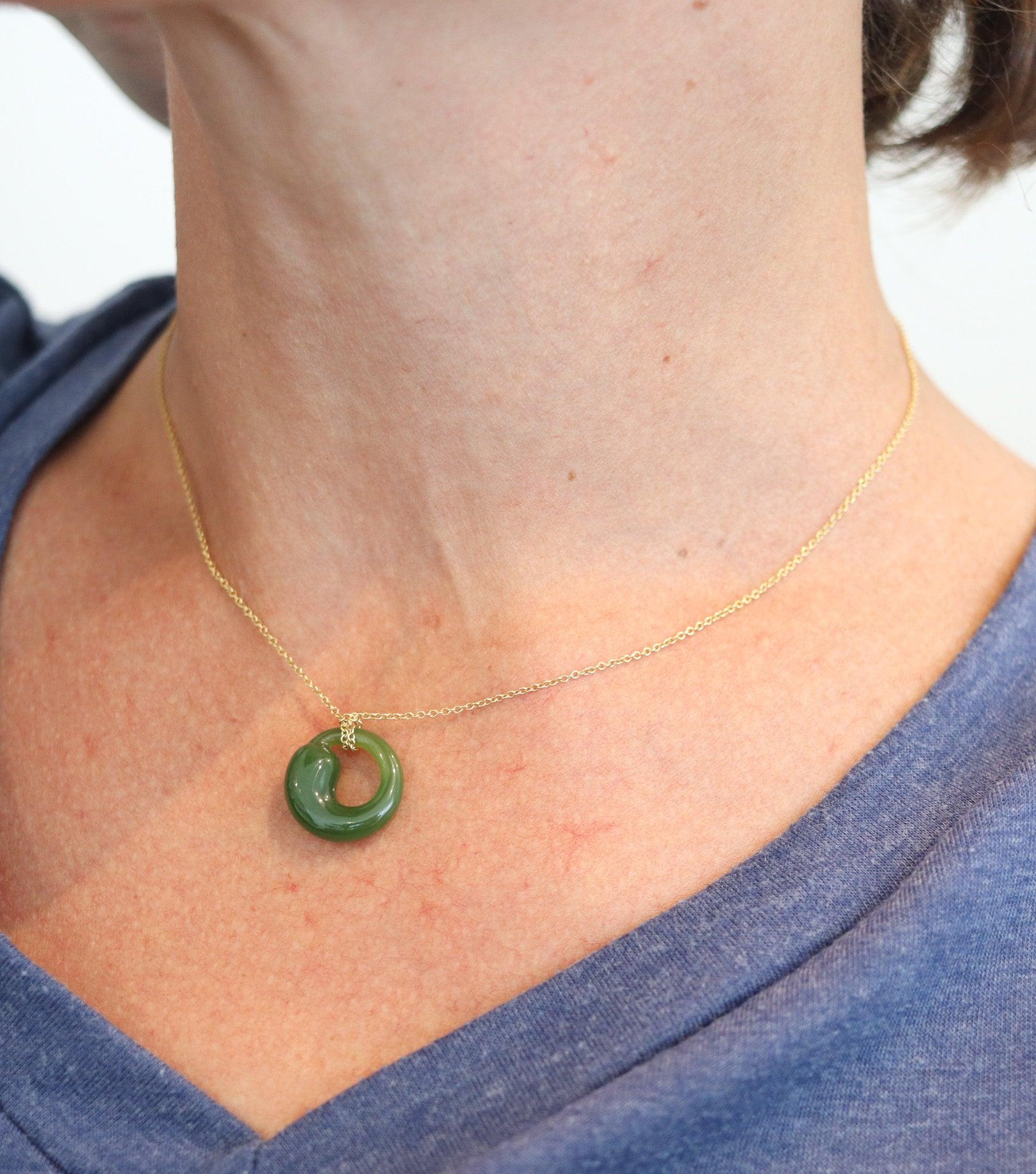 A necklace designed by Elsa Peretti (1940-2021) for Tiffany & Co.

The Eternal Circle is an iconic Elsa Peretti designs for Tiffany & Co. of the late 1970's. It was carved with smooth surfaces from natural vivid green nephrite, with great saturation