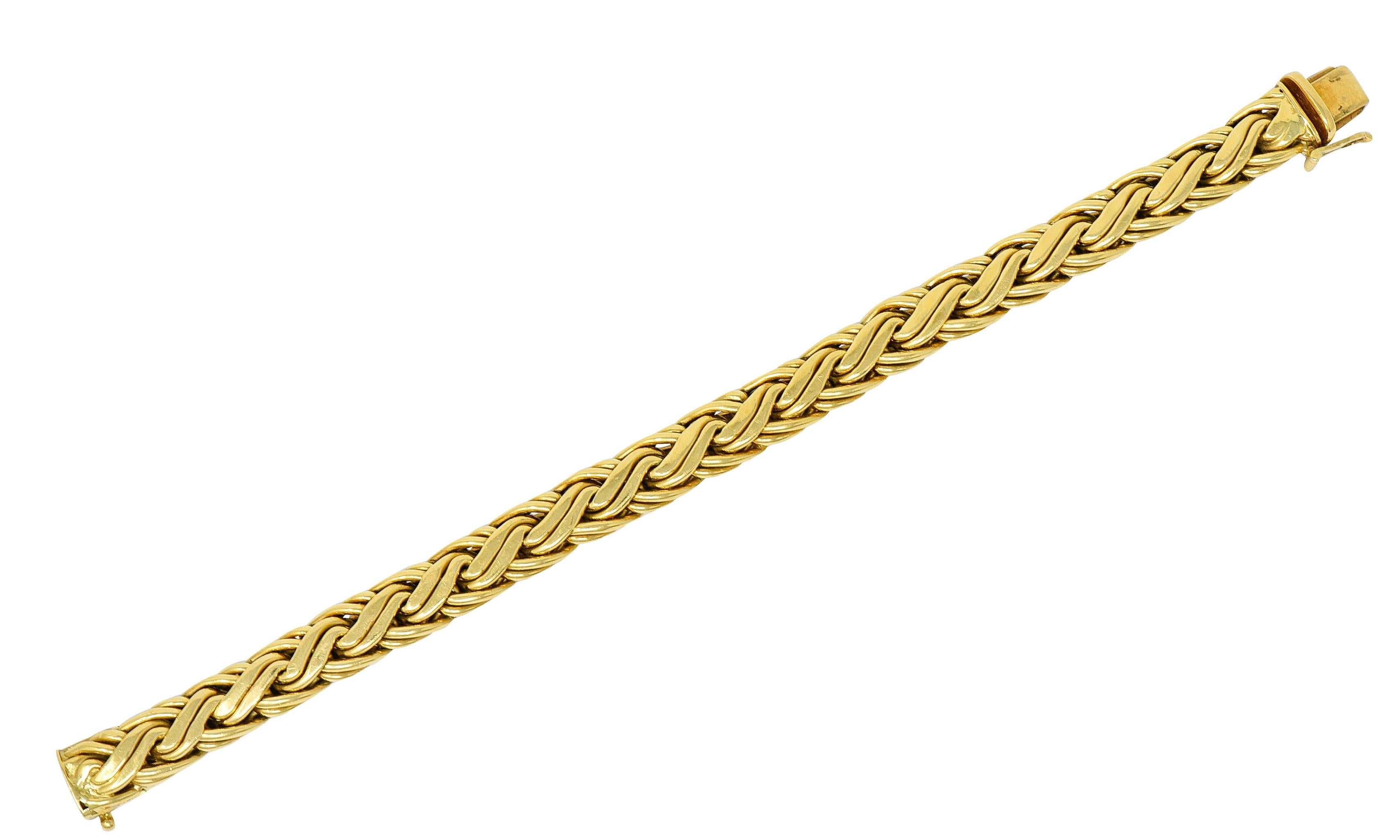 Wheat style chain link bracelet

With brightly polished braided links

Completed by a concealed clasp with a fold-over safety

Stamped 750 for 18 karat gold

Fully signed Tiffany & Co.

Circa: 1980s

Length: 7 1/2 inches

Width: 3/8 inch

Total
