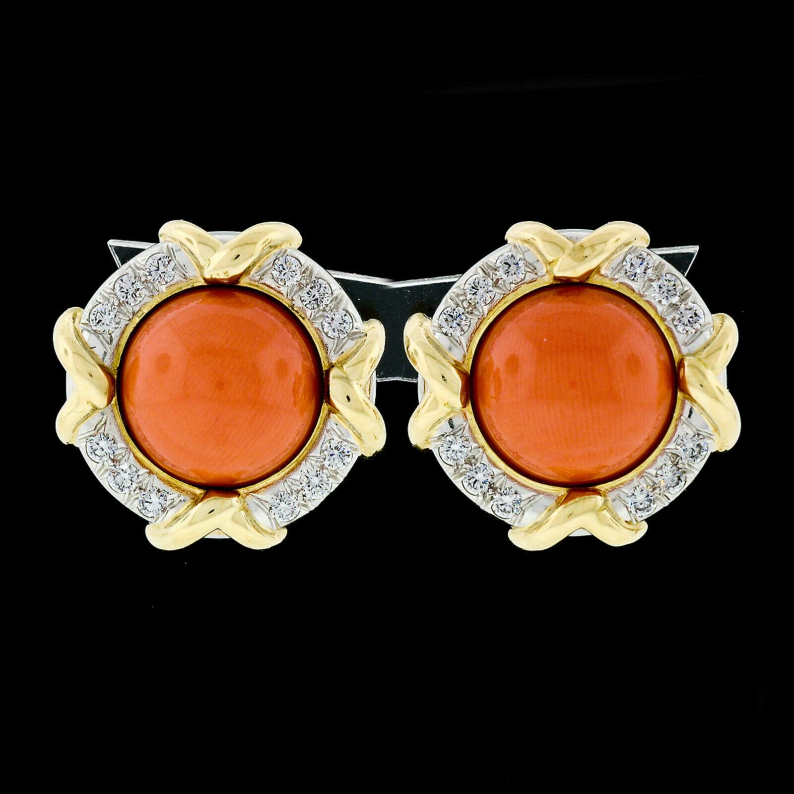 You are looking at a gorgeous pair of earrings that was designed in 1985 and crafted in solid 18k yellow gold and .950 platinum by Tiffany & Co. The earrings feature a pair of GIA certified, round cabochon cut, natural coral stones with a rich and