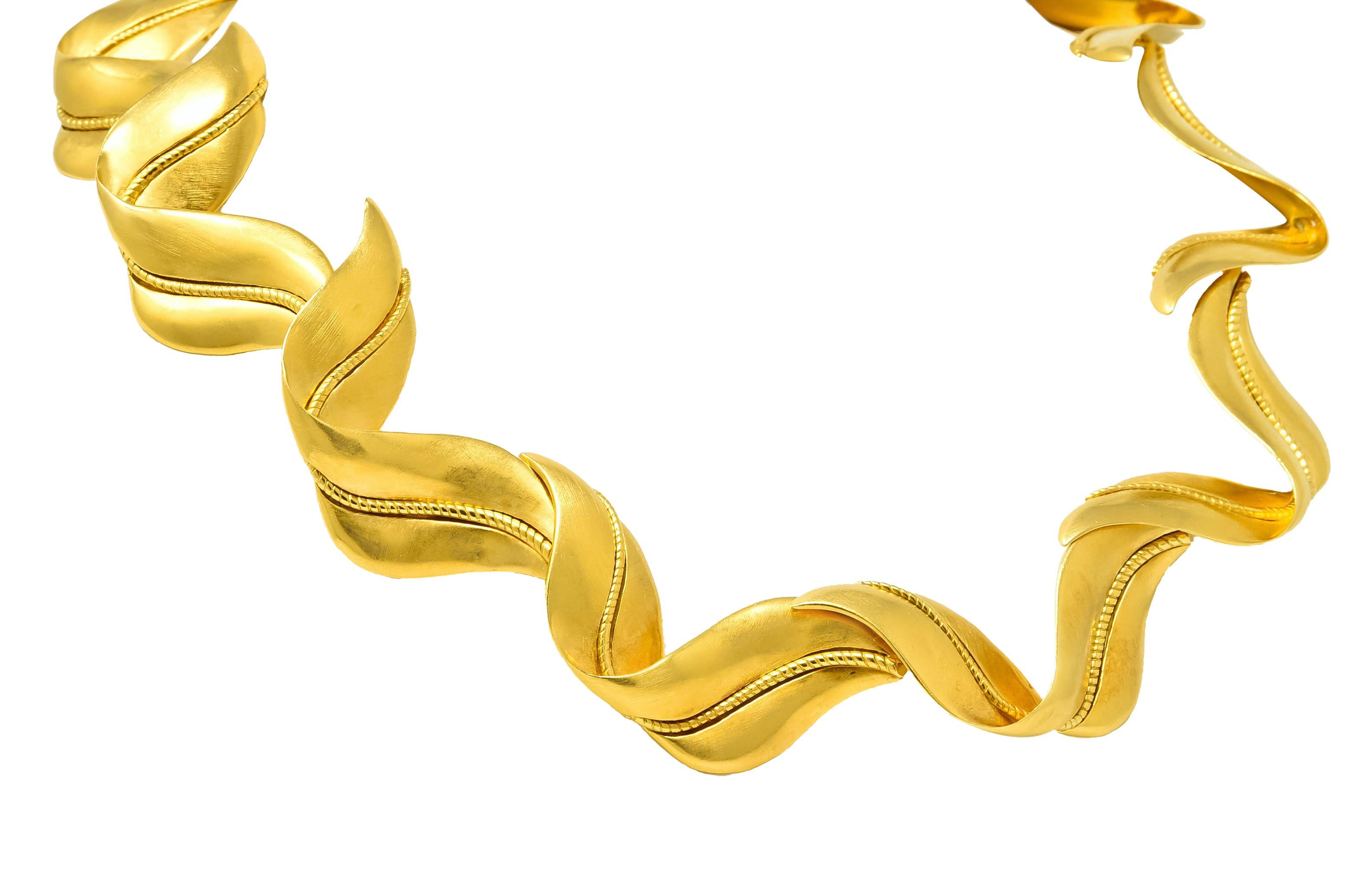 Collar style necklace comprised of matte gold, wispy, folded blades of grass links

Each centering a twisted cable motif stem

Completed by concealed hook and eye clasp

Fully signed Tiffany & Co. 1987 and attributed to Angela Cummings

Stamped 18k