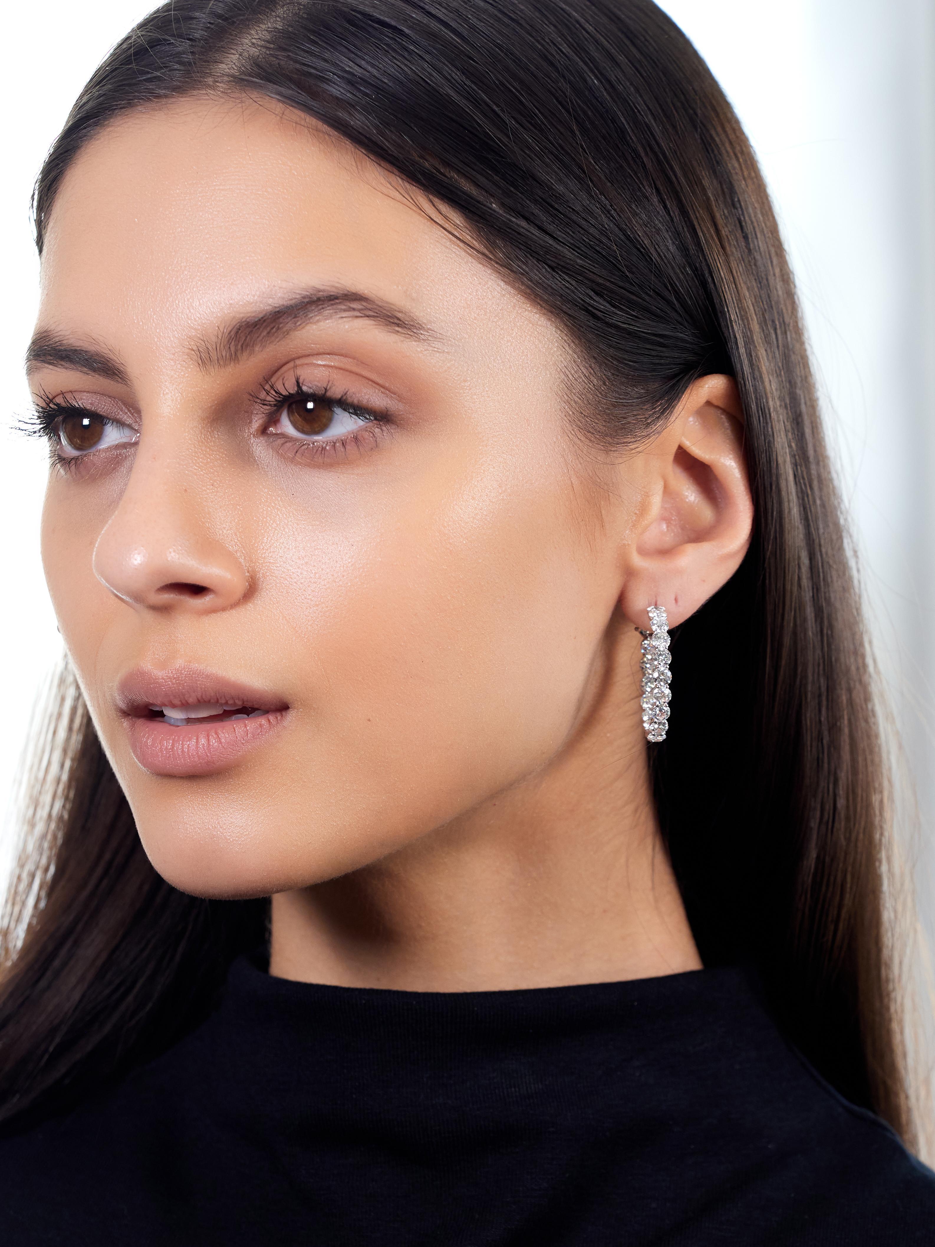 Designed as round hoops with round brilliant cut diamonds
Prong set in basket rows throughout in inside-outside style
Weighing approximately 8.50 carats total
F-G color with VVS-VS clarity
Completed by posts with hinged omega backs
Stamped for