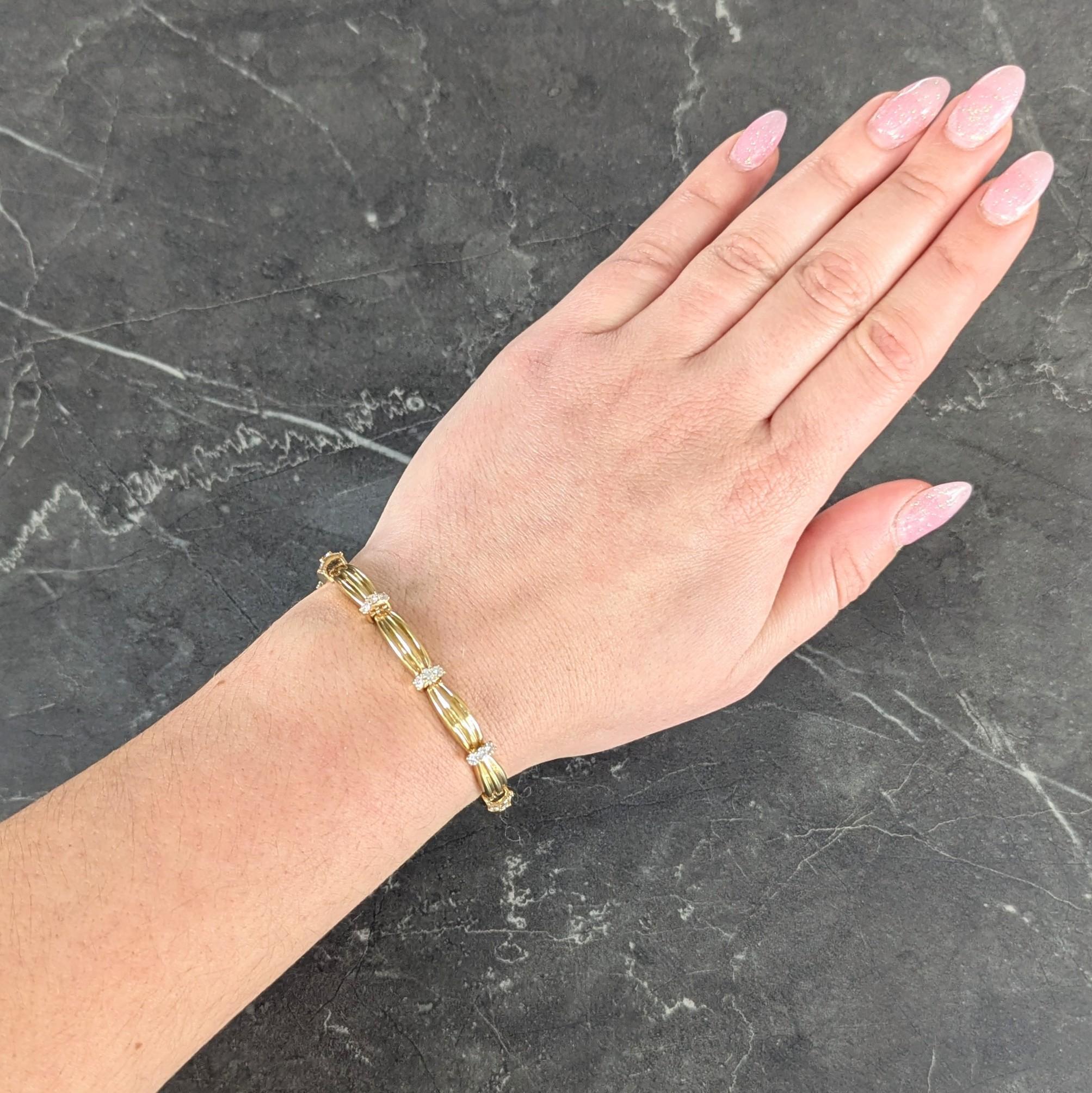 Link bracelet is comprised of curved bar links with fluted detail
Depicting a cinched ribbon motif and alternating with diamonds
Round brilliant cuts and prong set in rows
Weighing approximately 1.50 carats total
G/H color with VS2 clarity
With high