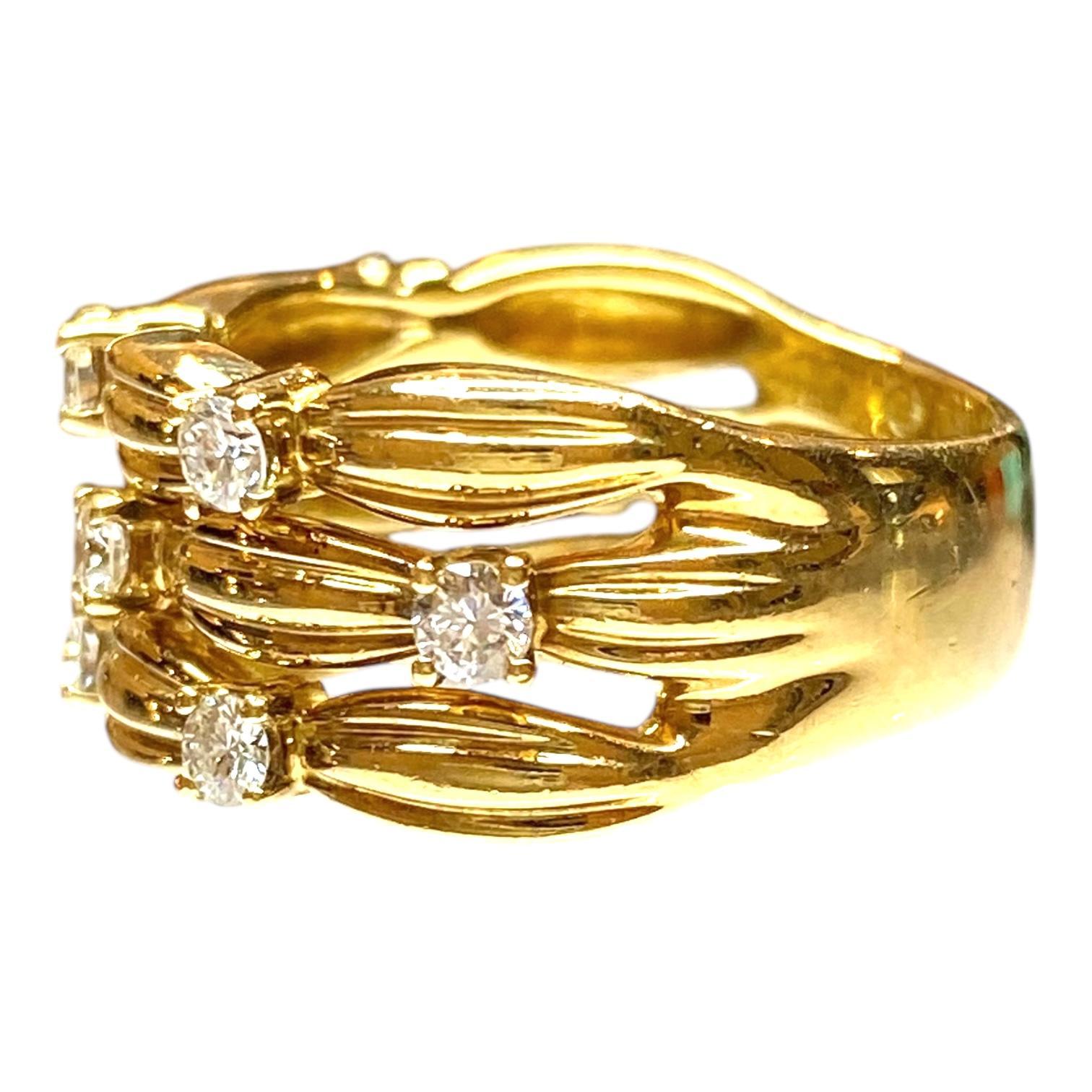 Vintage 18k yellow gold Tiffany & Co. diamond band ring from the Signature Series collection, created in 1992. It features three ribbed bands with a basket weave design scattered with ten brilliant cut diamonds. Box included.
Diamonds: 0.60ctw.