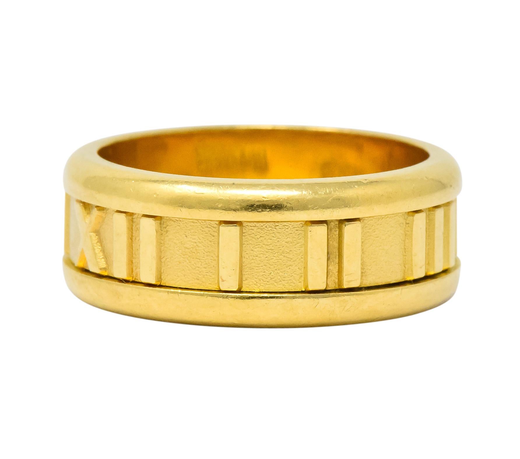 Featuring a wide 18 karat gold band ring from the Atlas Collection

With Roman numerals and borders in highly polished gold

Matte finish on lightly textured background

Fully signed Tiffany & Co. 1995 Italy 750 (for 18 karat gold)

Ring size: 5 1/2