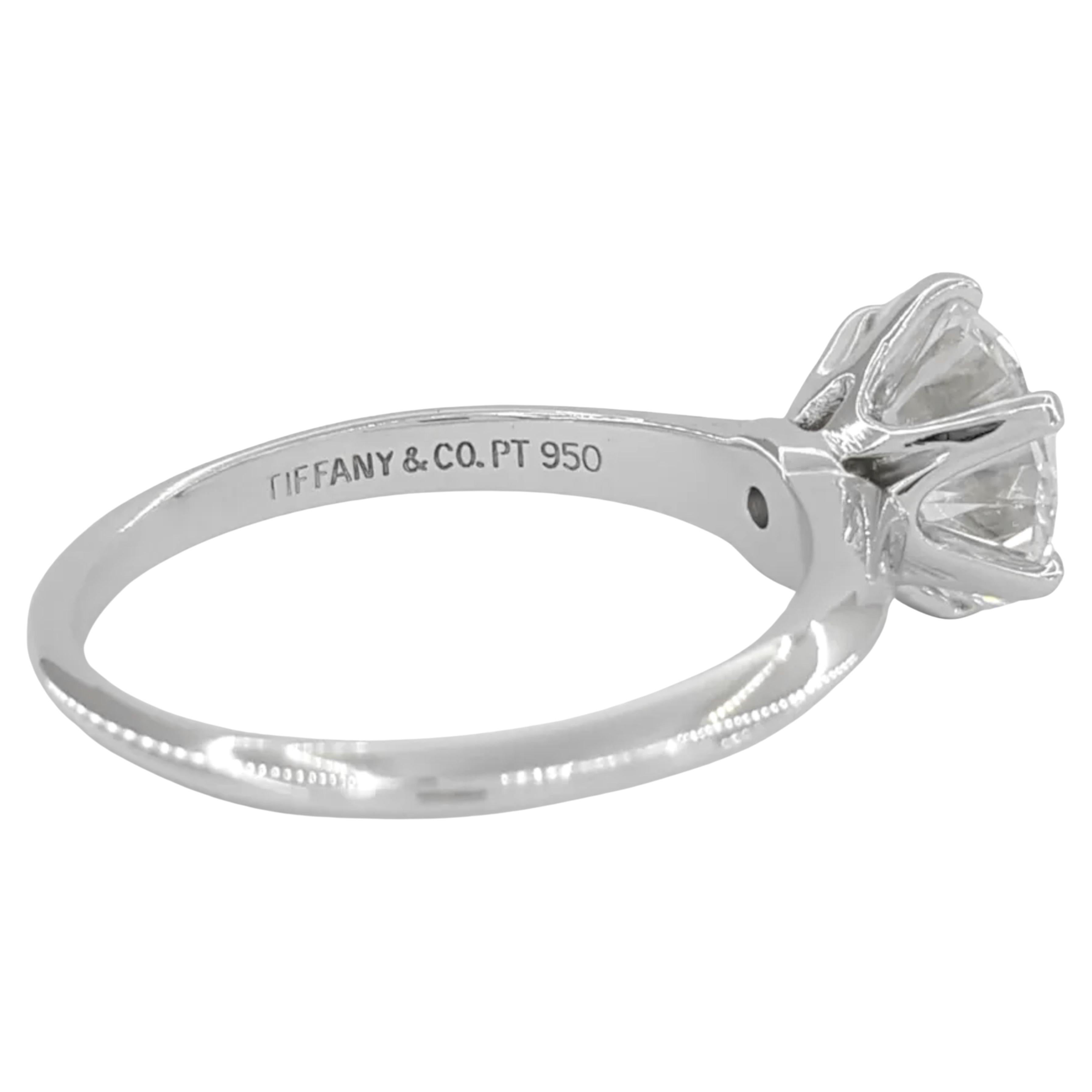 Tiffany & Co. engagement ring you described showcases a total diamond weight of 2.02 carats, making it a substantial solitaire. The center stone is a natural Round Brilliant Cut diamond with an exceptional D color rating, denoting it as colorless,