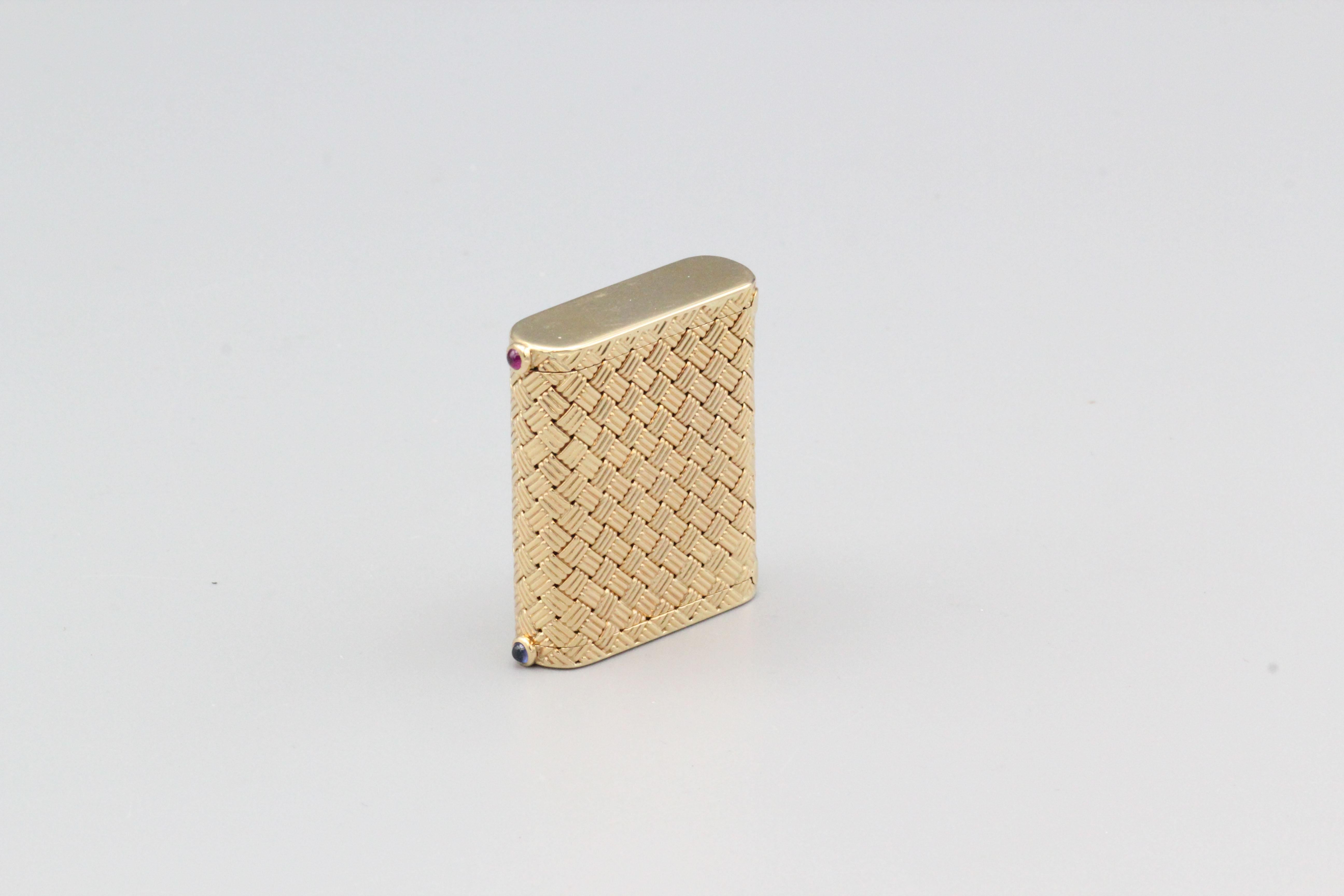 Fine 2 section 14k yellow gold basket weave pill box with ruby and sapphire cabochons, by Tiffany & Co. circa 1950s.

This Tiffany & Co. pill box is an elegant and functional piece of vintage jewelry. This pill box is crafted from high-quality 14k