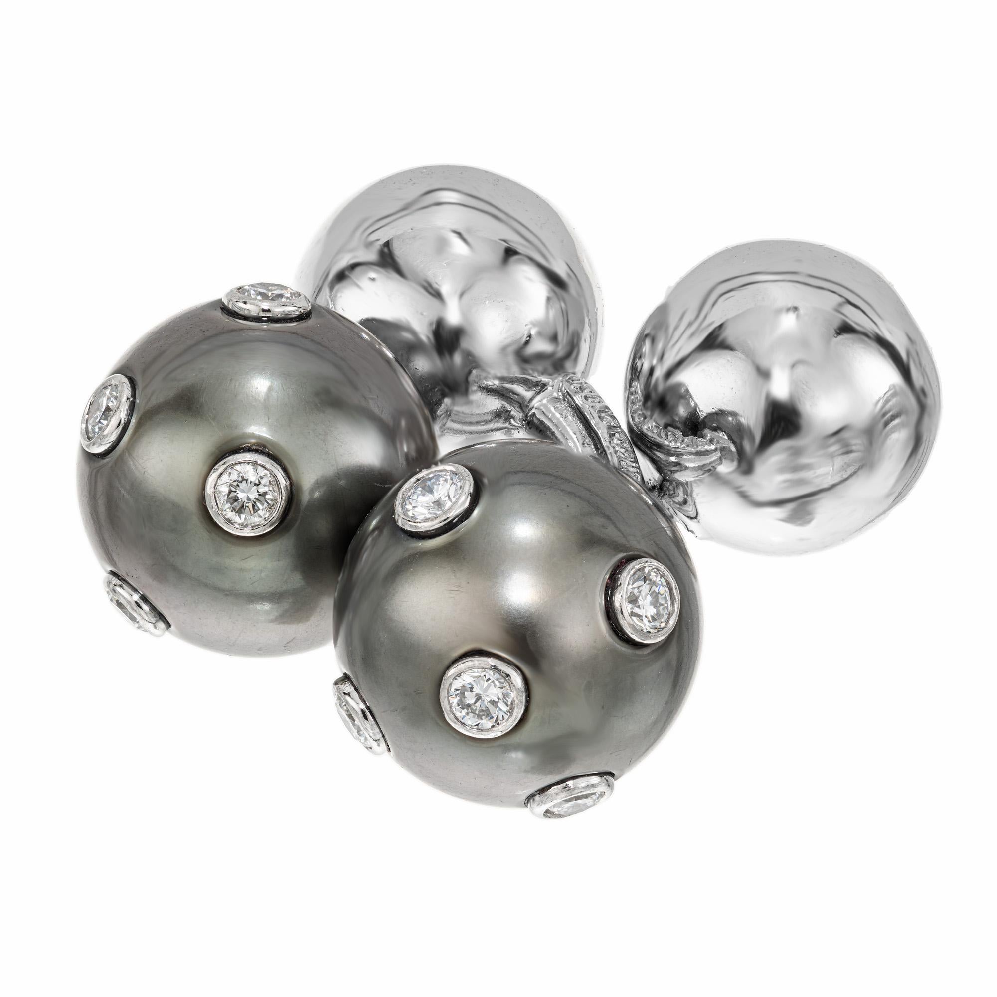 Black pearl and diamond Tiffany & Co. cufflinks.  Theses cultured black pearl platinum barbell cufflinks are decorated with 10 round bezel set diamonds, totaling .20cts. on one end. On the apposite end are platinum balls. Another example of