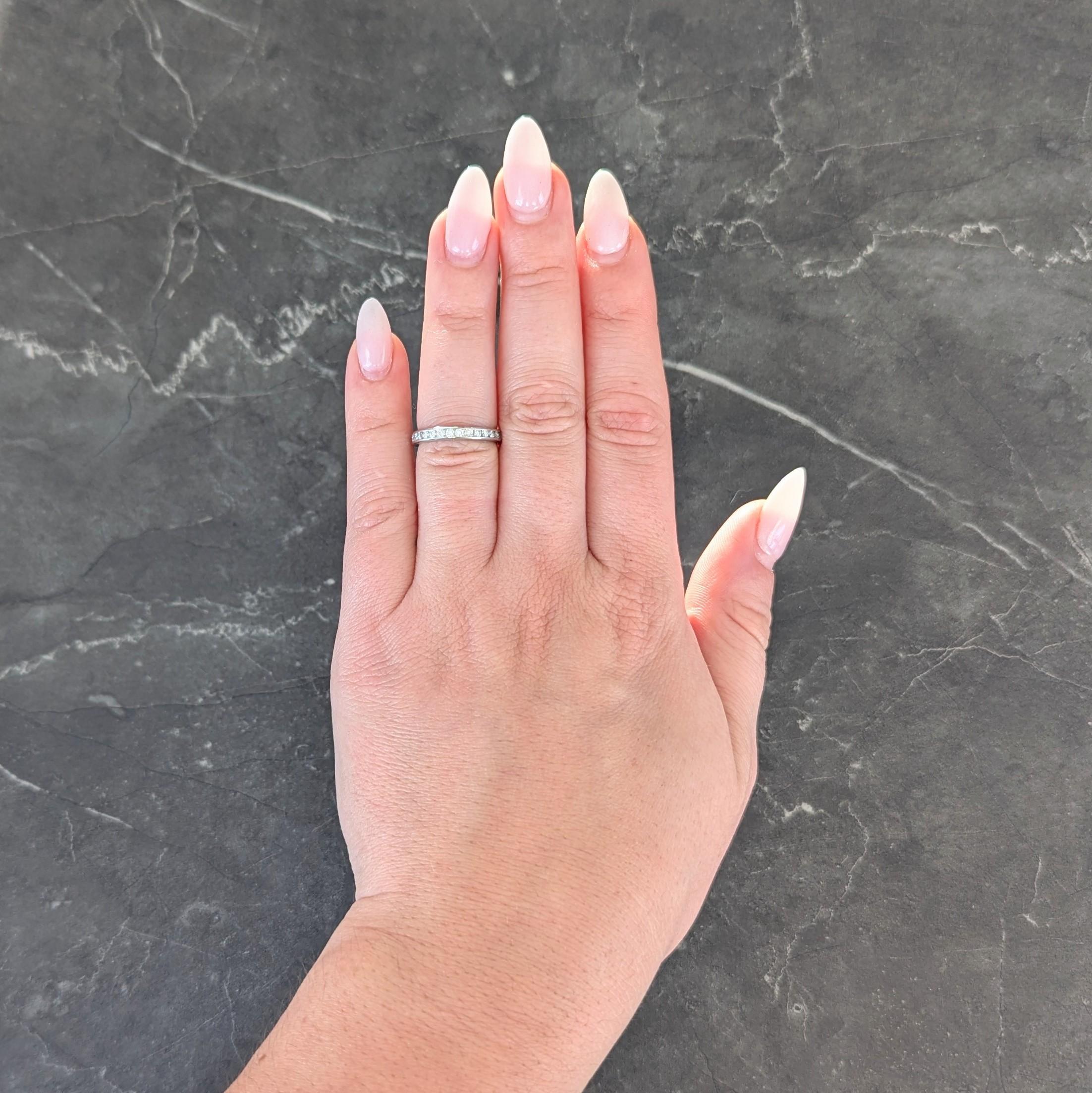 Featuring round brilliant cut diamonds channel set fully around
Weighing approximately 0.90 carat total
G color with VS2 clarity
Stamped for platinum
Numbered and fully signed for Tiffany & Co.
Circa: 2000s
Ring Size: 4 1/2 and not sizable
Measures