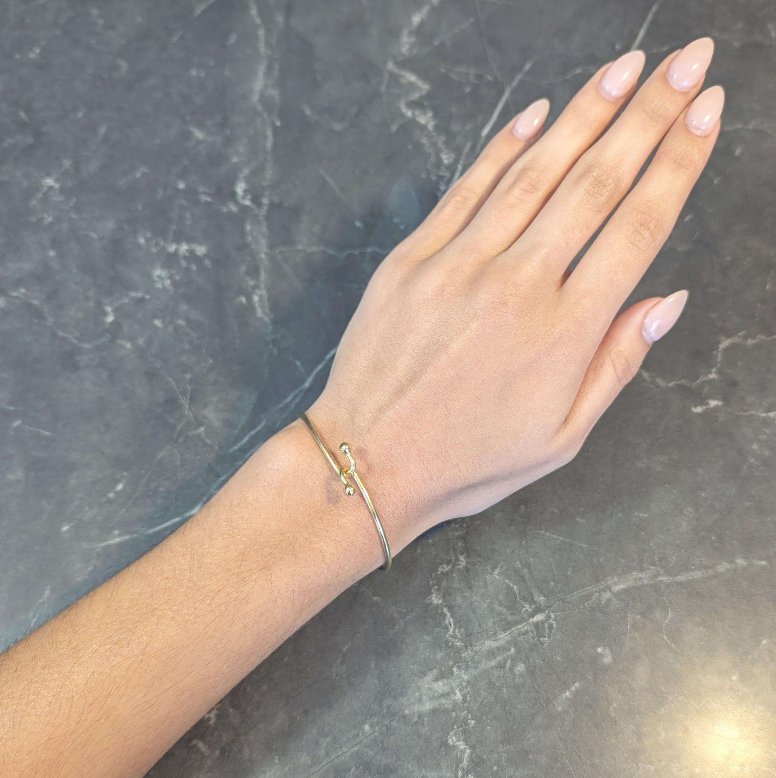 Tiffany & Co. 2000's 18 Karat Yellow Gold Interlocking Hook Bangle Bracelet In Excellent Condition In Philadelphia, PA