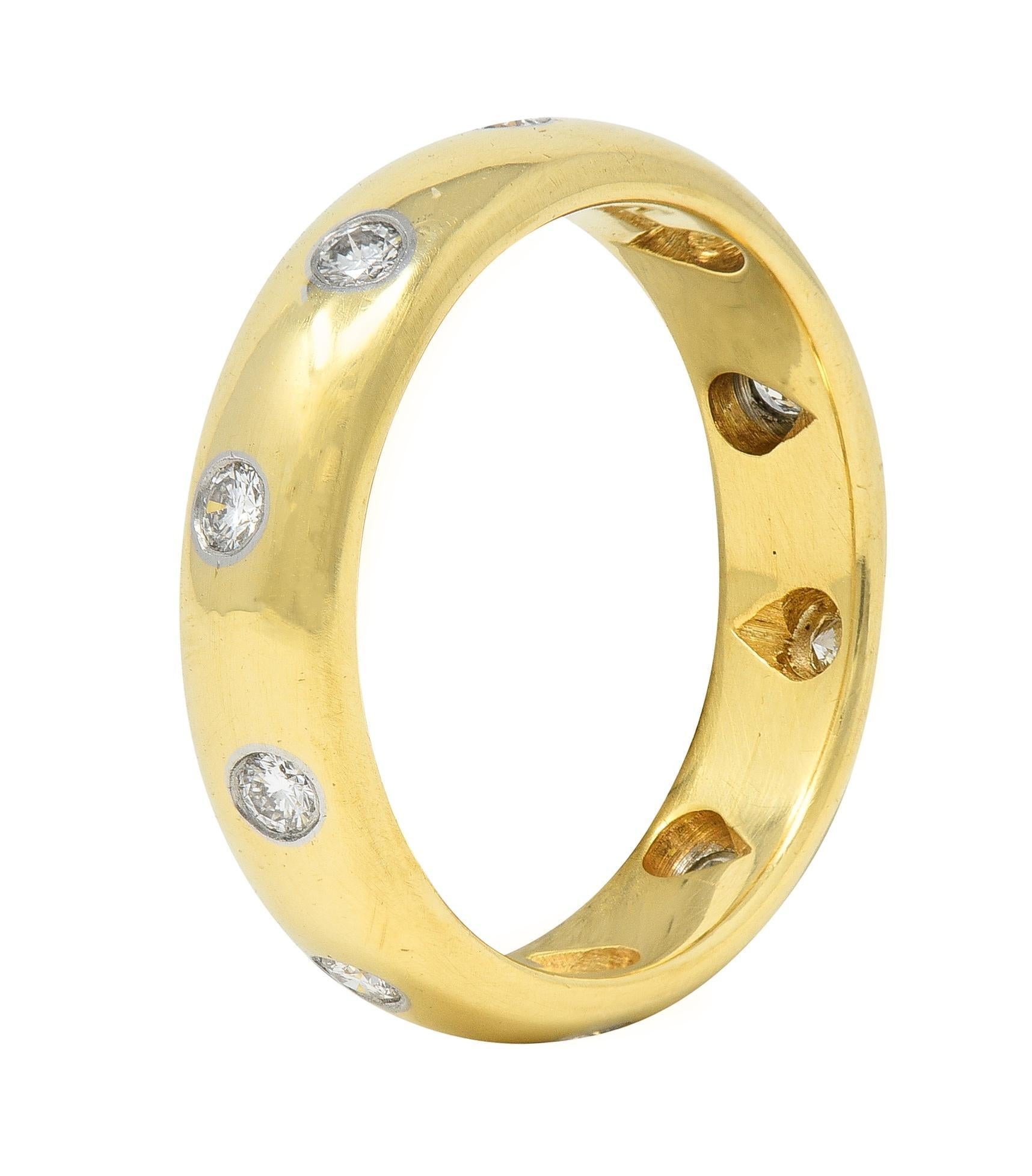 Designed as a curved yellow gold band with round brilliant cut diamonds 
Weighing approximately 0.30 carat total - G color with VS1 clarity
Flush set in platinum sporadically throughout 
Completed by high polish finish
Stamped for 18 karat gold and