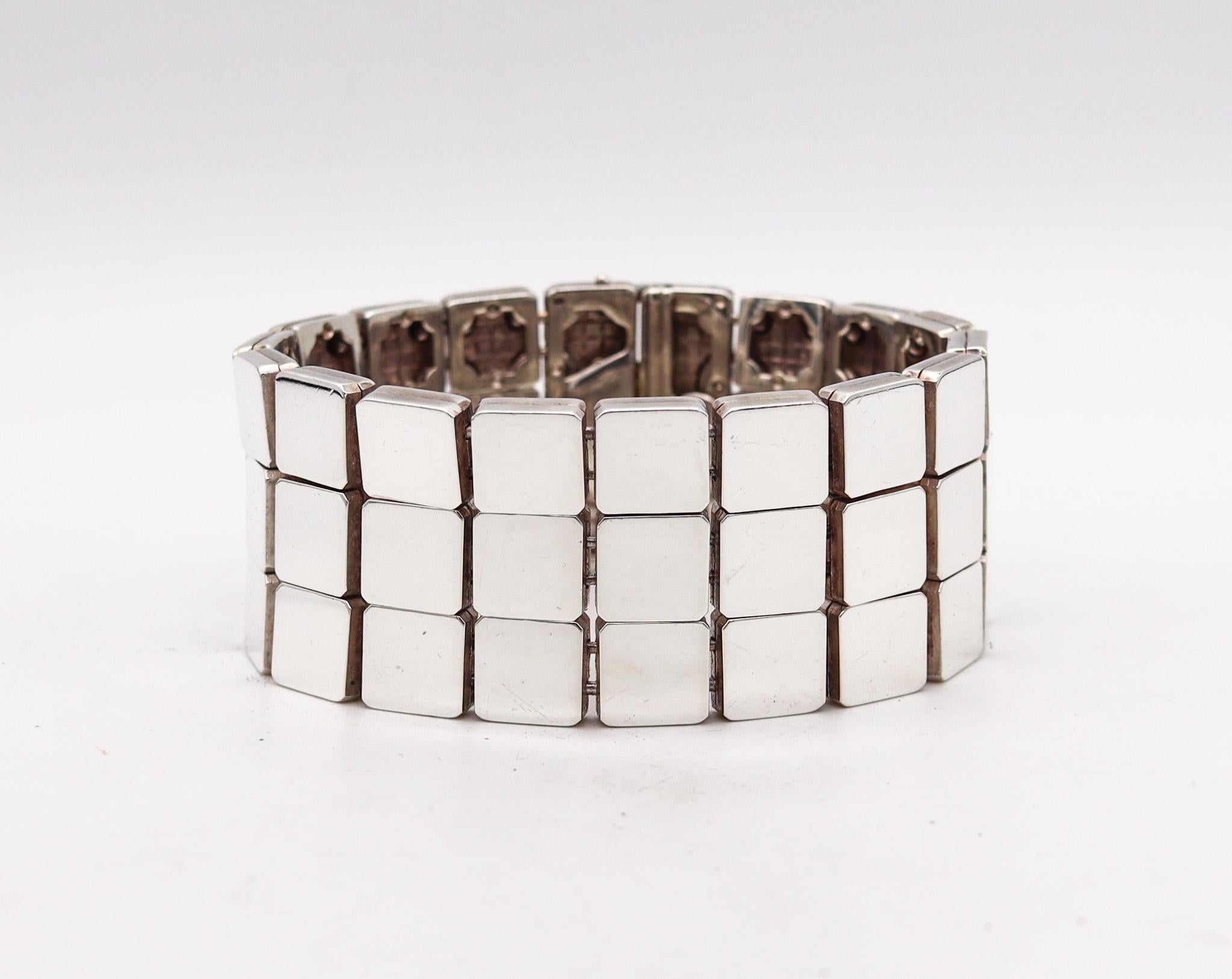 Geometric bracelet designed by Tiffany & Co.

This is a very rare architectural bracelet, created by the Tiffany Studios, back in the 2002. Constructed by fifty four square elements divided in three rows carefully crafted by artisans in solid