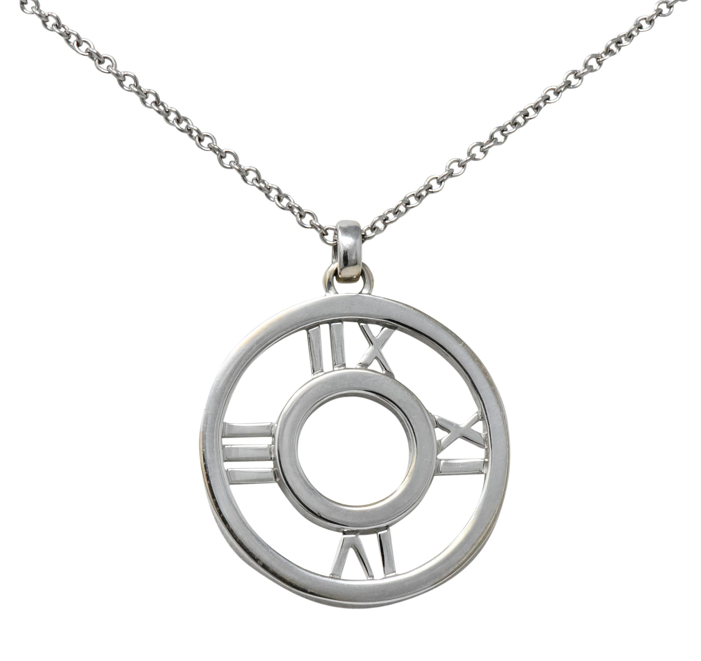Centering a circle of bead set, round brilliant cut diamonds weighing approximately 0.30 carat, G/H color and VS to SI clarity

Surrounded by high polished Roman numerals and highly polished circle and bale

Accompanied by white gold cable chain