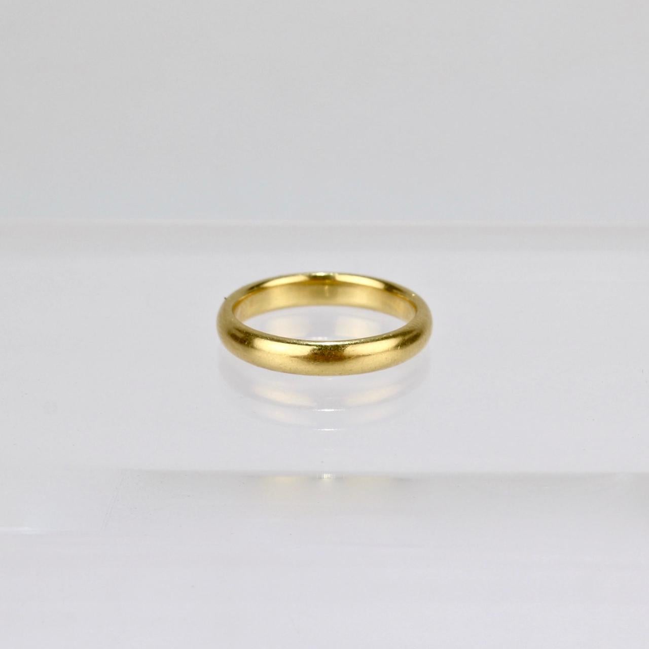A very fine Tiffany & Co. 22-Karat yellow gold ring.

A single band perfect in its simplicity.

An ideal wedding band (or even everyday ring).

Width: ca. 3 mm
Overall Diameter: 19mm
Ring Size (on a mandrel): ca. 5.5-5.75

The interior is stamped: