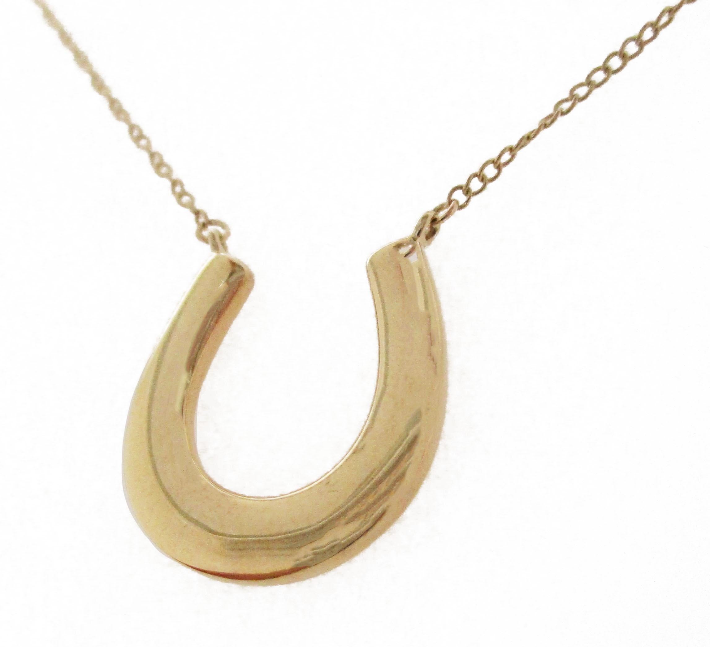 This gorgeous necklace brings all the charm of Tiffany & Co. as a stunning 18k yellow gold horseshoe! The 18k yellow gold horseshoe sits at the center of the necklace and is attached to the chain for a delicate, articulated finish! The smooth,