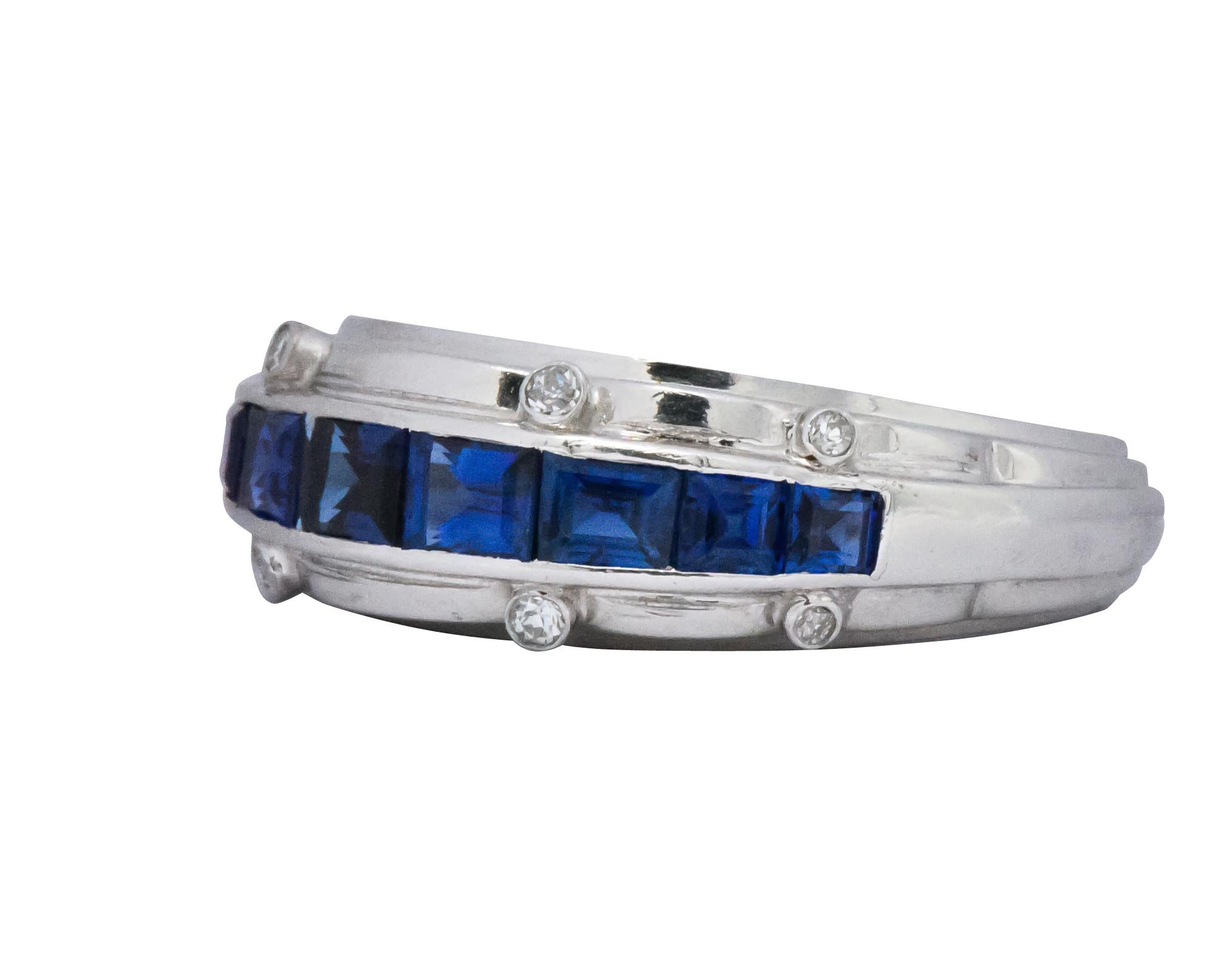 Tiffany & Co. 1940’s platinum sapphire and diamond ring.  9 rich and beautifully matched channel set rectangular cut blue sapphires weighing approximately  2.50 carat total

Accenting the channel set sapphires are 8 bezel set clean white single cut