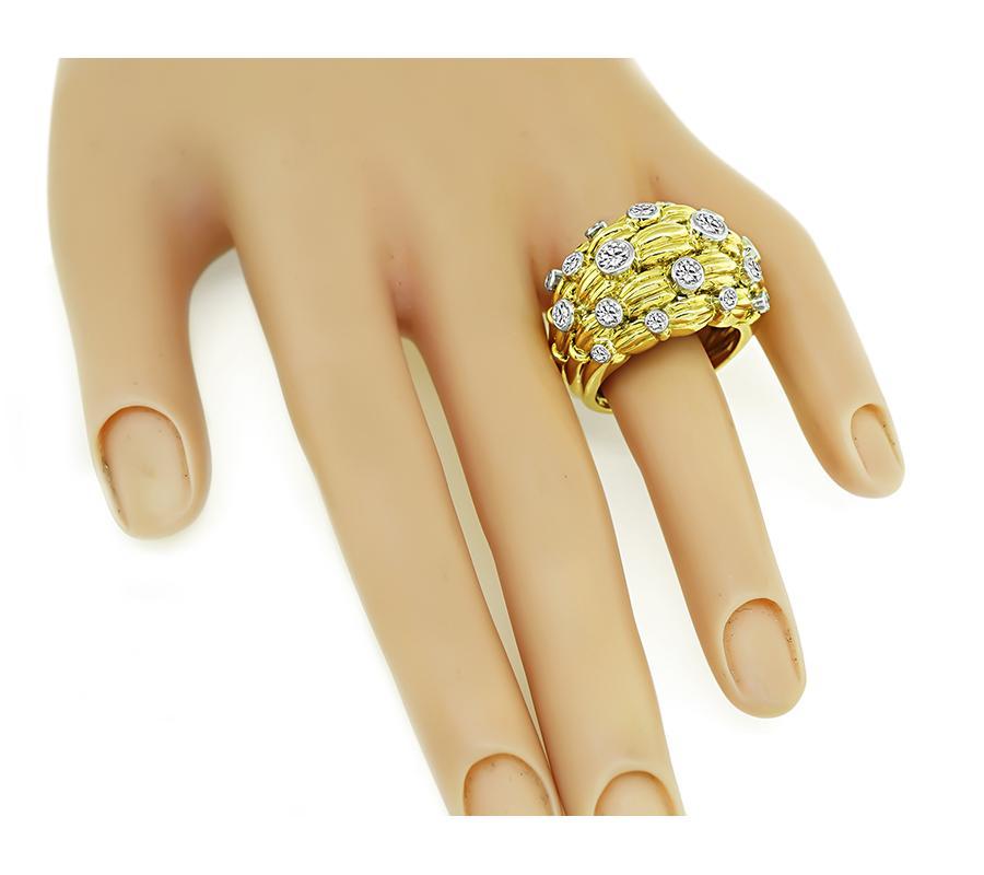 This is an elegant 18k yellow and white gold ring by Tiffany & Co. The ring is set with sparkling round cut diamonds that weigh approximately 2.50ct. The color of these diamonds is E-F with VS clarity. The ring has a tapering width from 6.5mm to