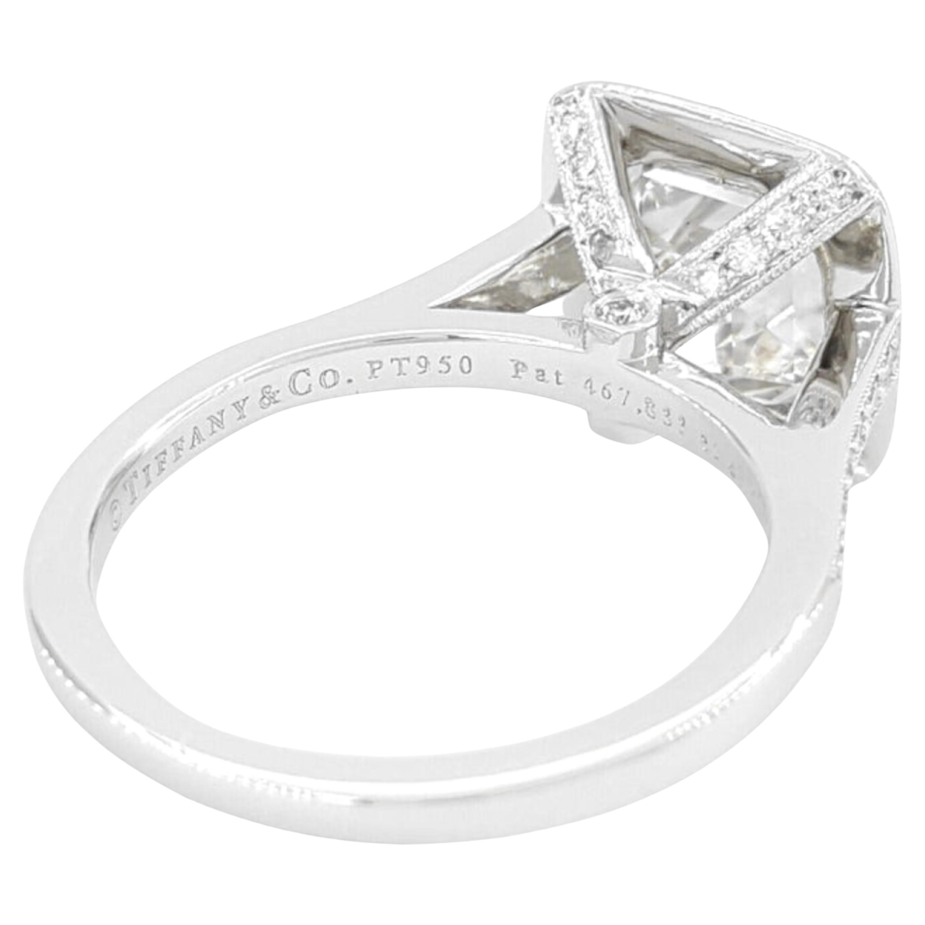 Tiffany & Co. 2.53 ct Total Weight Platinum Legacy Cushion Brilliant Cut Diamond Engagement Ring features a stunning center stone, a Legacy Cushion Brilliant Cut diamond weighing 2.17 ct. This diamond is of exceptional quality, with a D color rating
