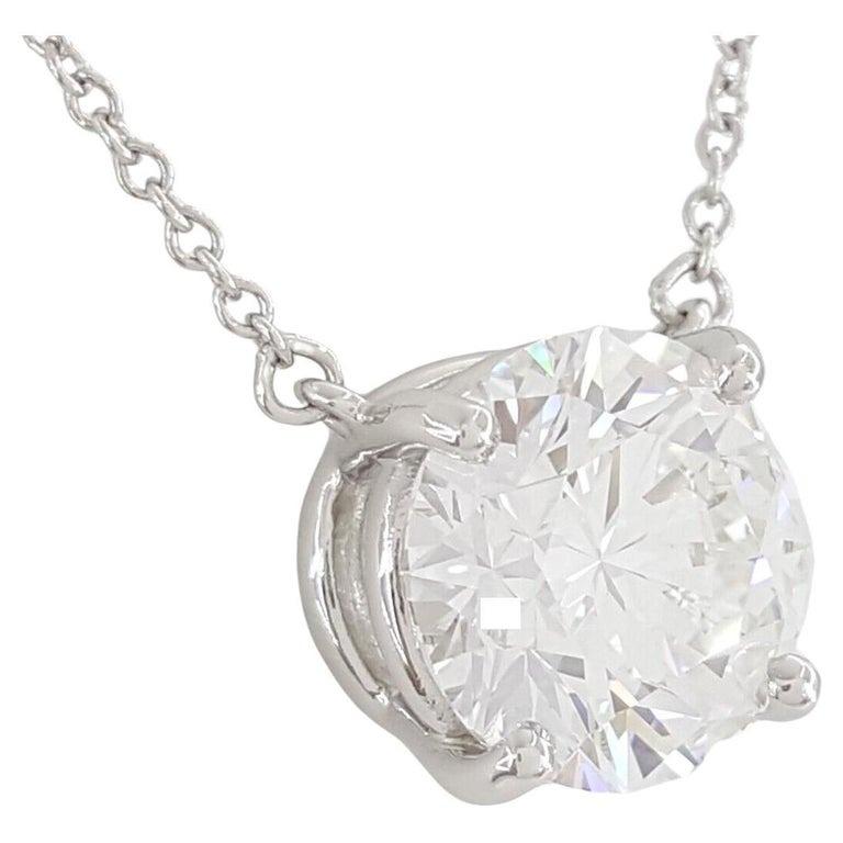 TIFFANY & CO. 2.91 ct Round Brilliant Cut Diamond Solitaire Pendant is a striking piece of jewelry. It features a natural Round Brilliant Cut diamond weighing 2.91 ct, graded E in color and VVS2 in clarity. The diamond exhibits an excellent cut,