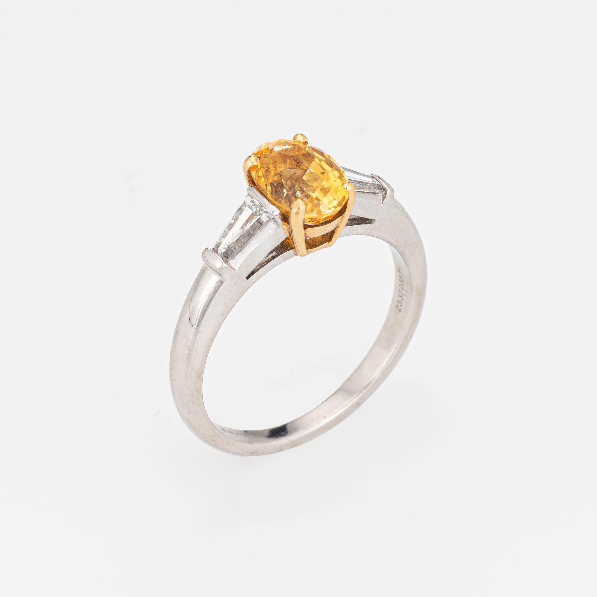 Estate Tiffany & Co yellow sapphire & diamond ring crafted in platinum & 18 karat yellow gold (circa 1990s to 2000s).  

Oval faceted yellow sapphire measures 7.8mm x 5.6mm (estimated at 2 carats). Two baguette diamonds are estimated at 0.10 carats