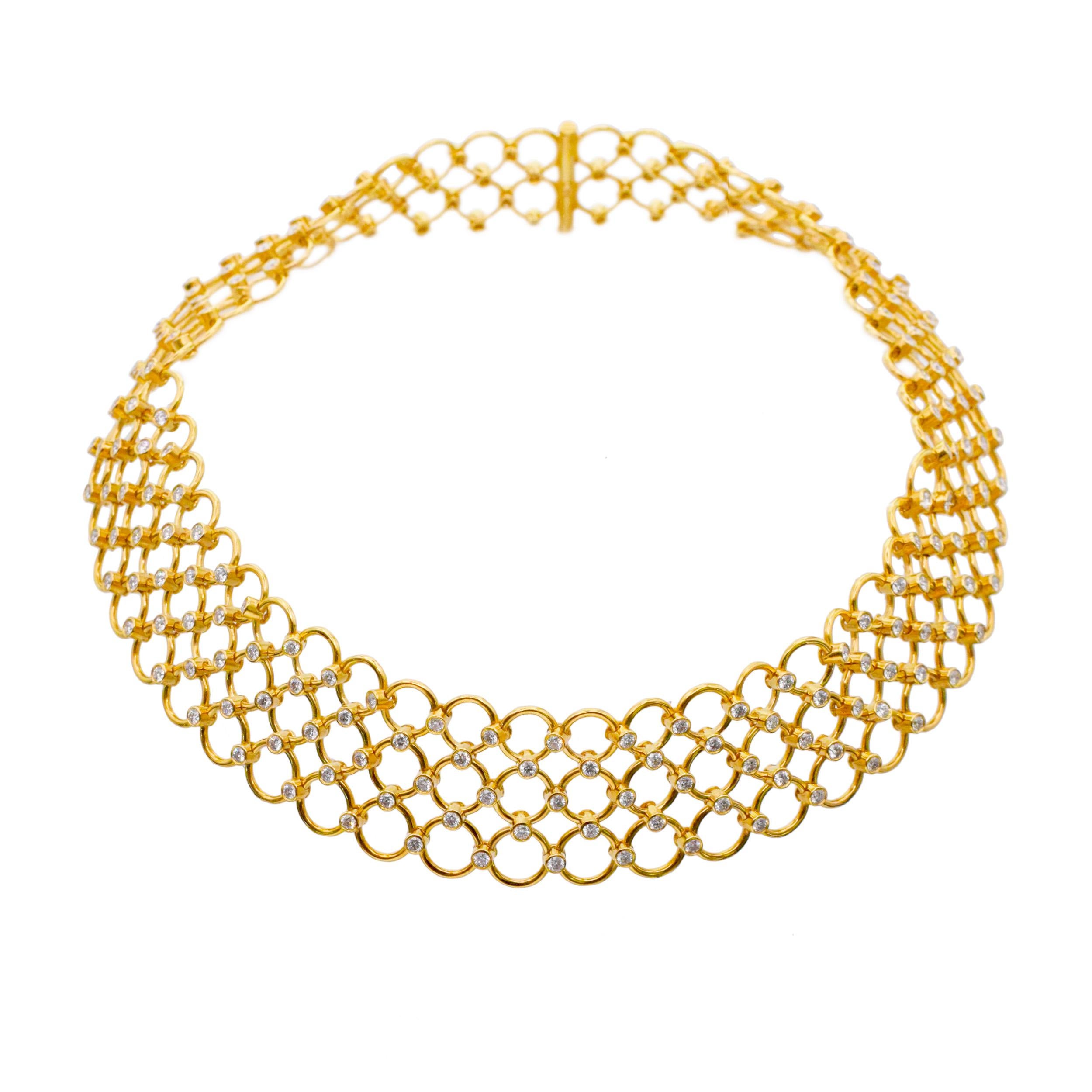 Tiffany & Co. 18k yellow gold 3-row circular link choker necklace with diamonds. This flexible necklace features three rows of graduating in size
circular yellow gold links, connected by bezel set diamond joints. Equipped with slide in barrel slide