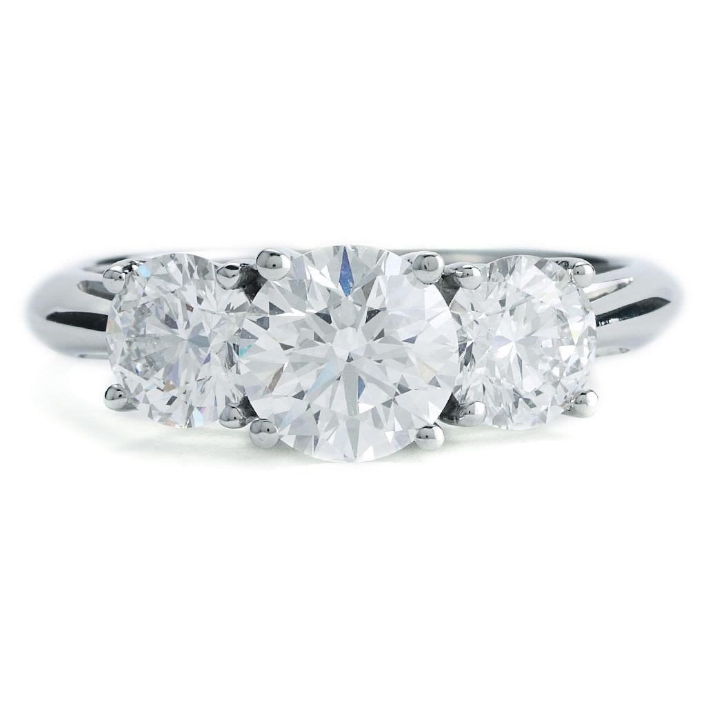 This Tiffany & Co 3-stone diamond engagement ring is made of platinum and weighs 3.40 DWT (approx. 5.29 grams). It contains one round g, VS1 clarity diamond weighing 1.10 ct. , 2 round g and VS1 clarity diamonds weighing 1.14 ct. Ring Size 7.
