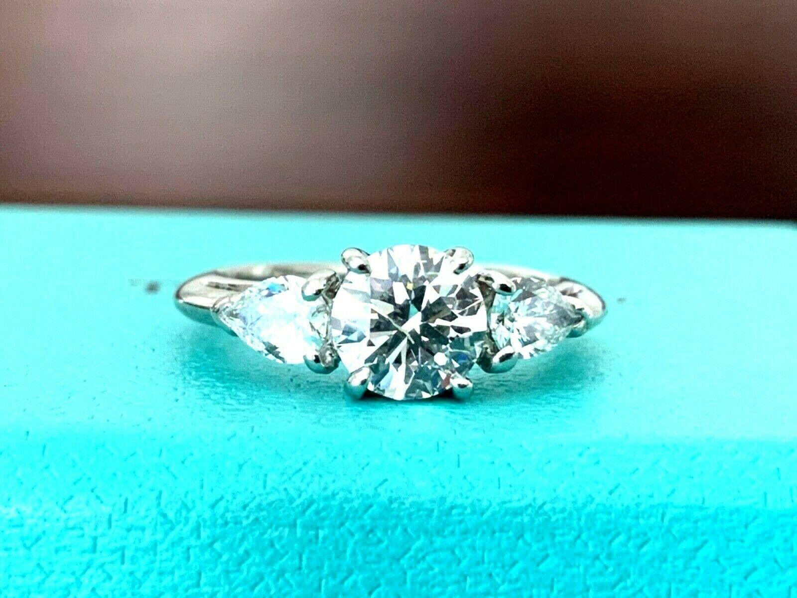 Being offered for your consideration is a stunning 3 stone Round and Pear Shaped Side Diamond Tiffany & Co engagement ring or anniversary ring.  This ring can be paired with another or worn as a cocktail ring or anniversary band - it is extremely