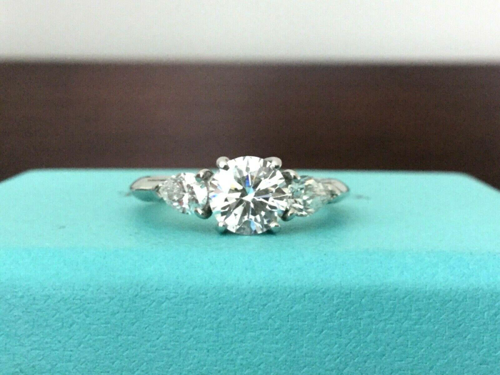 Being offered for your consideration is a stunning 3 stone Round and Pear Shaped Side Diamond Tiffany & Co engagement ring or anniversaryring.  This ring can be paired with another or worn as a cocktail ring or anniversary band - it is extremely