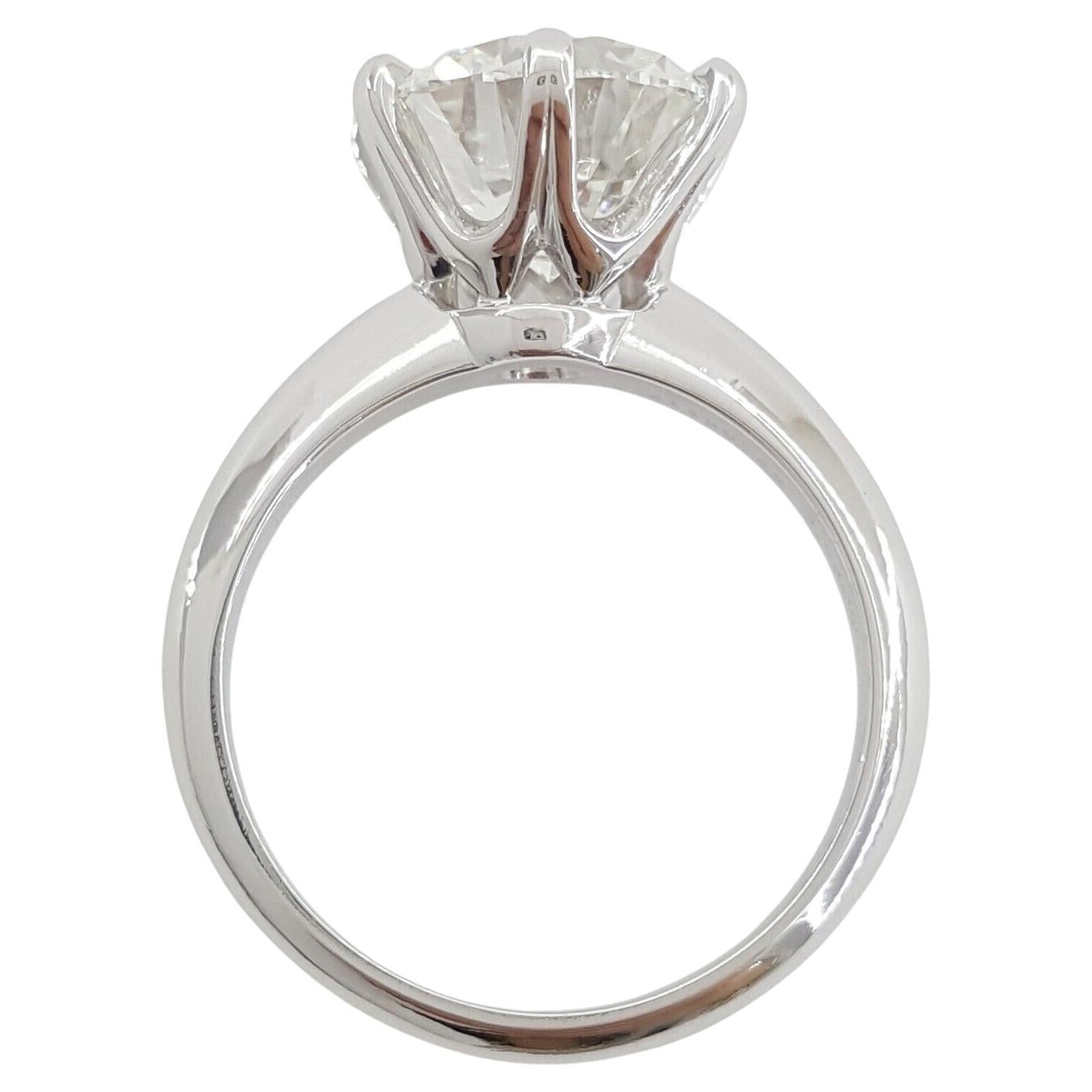This exquisite engagement ring from Tiffany & Co. is a paragon of classic elegance, meticulously crafted in platinum. The ring, with a weight of 6.6 grams and sized at 5.75, offers a balanced and comfortable fit, and can be sized to accommodate most