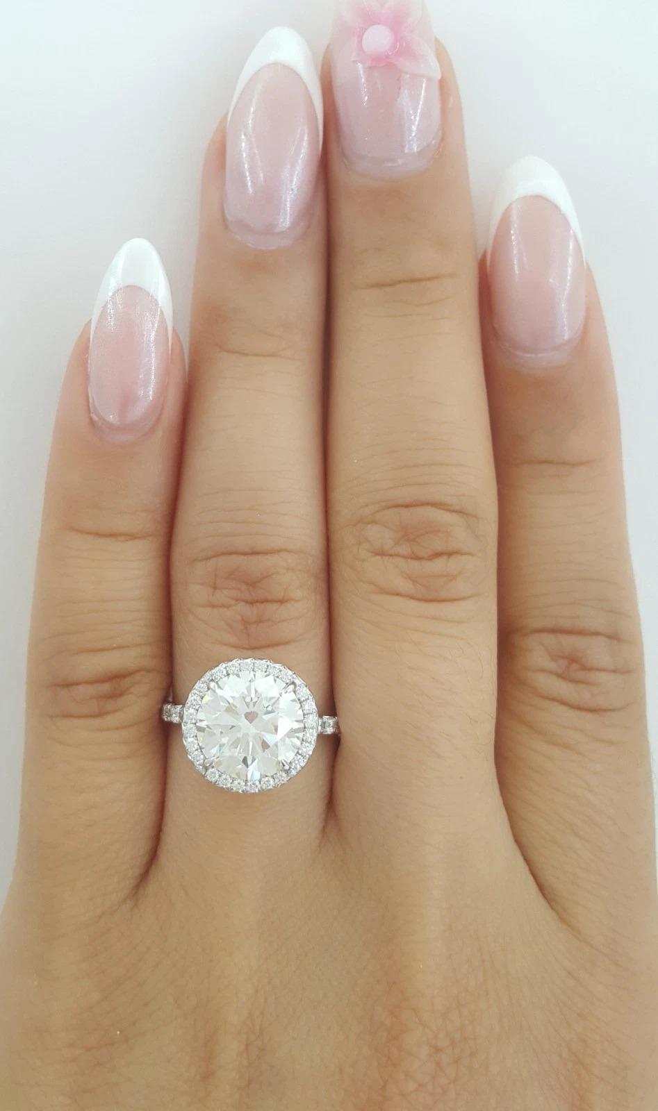 Tiffany & Co. 3.82 Carat Platinum Soleste Diamond Halo Engagement Ring

An iconic Tiffany & Co. Soleste engagement ring showcasing a remarkable 3.30 carat Natural Round Brilliant Cut diamond at its center, certified by Tiffany & Co.

Center Diamond: