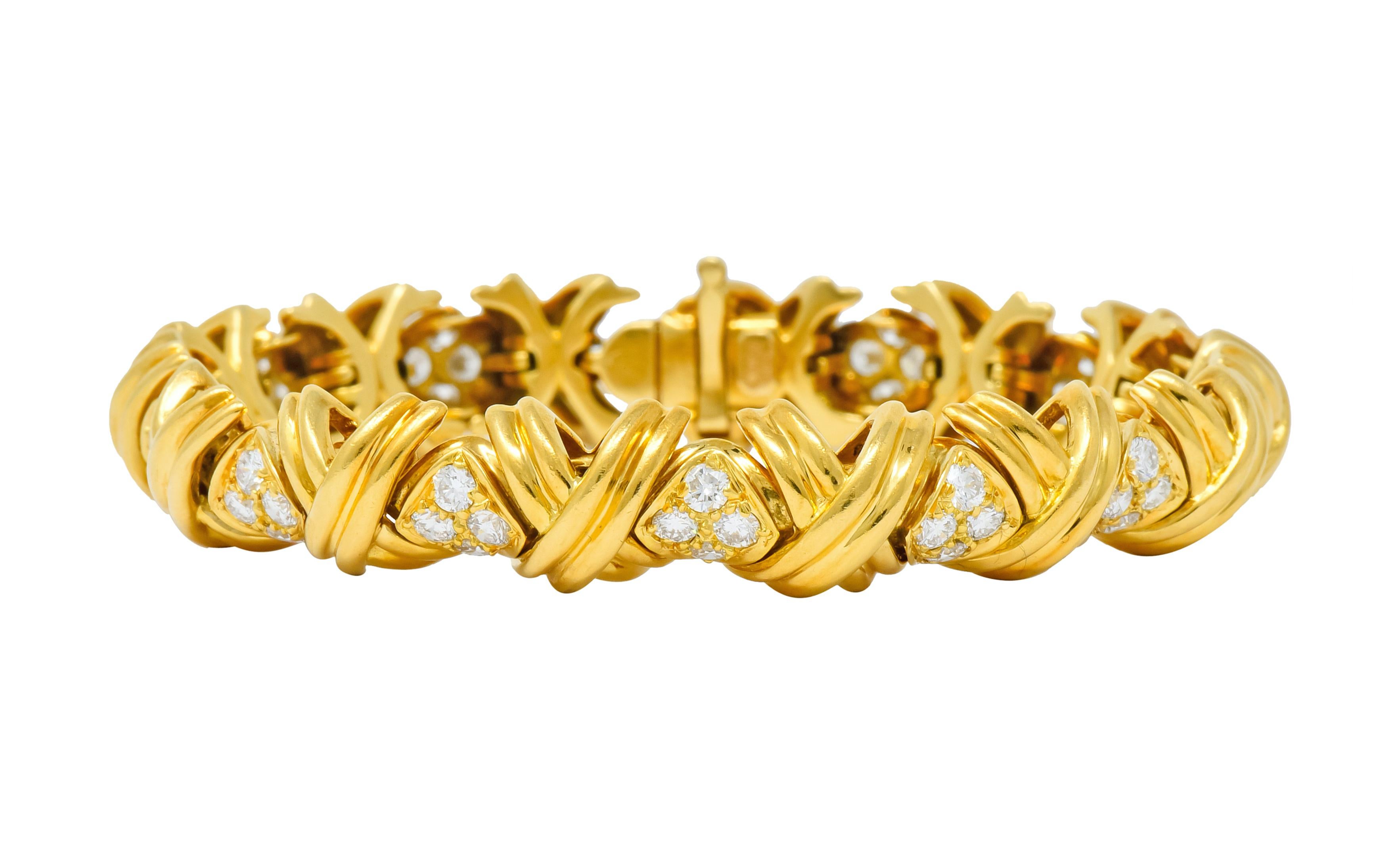 Link style bracelet comprised of deeply grooved X links

Alternating with navette spacer links pavé set with round brilliant cut diamonds weighing approximately 3.92 carats total, G/H color and VS clarity

Completed by concealed clasp with hinged