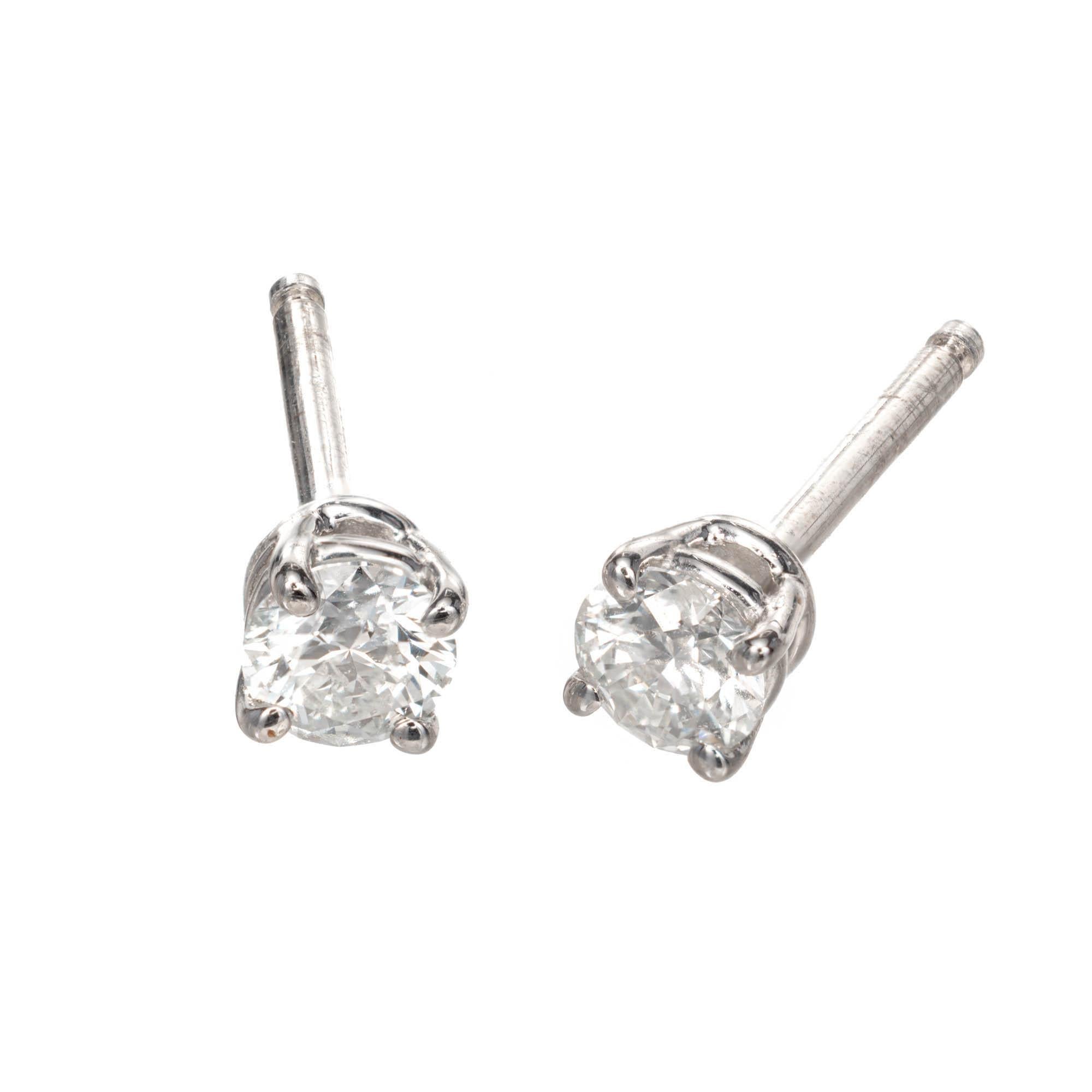 Tiffany & Co solitaire diamond stud earrings. Round brilliant cut diamonds set in platinum matched for size, color, clarity.

2 round brilliant cut H VSI diamonds, Approx. .40ct 
Tiffany & Co diamond certificate: 18608154/ E10080009.  18608154/